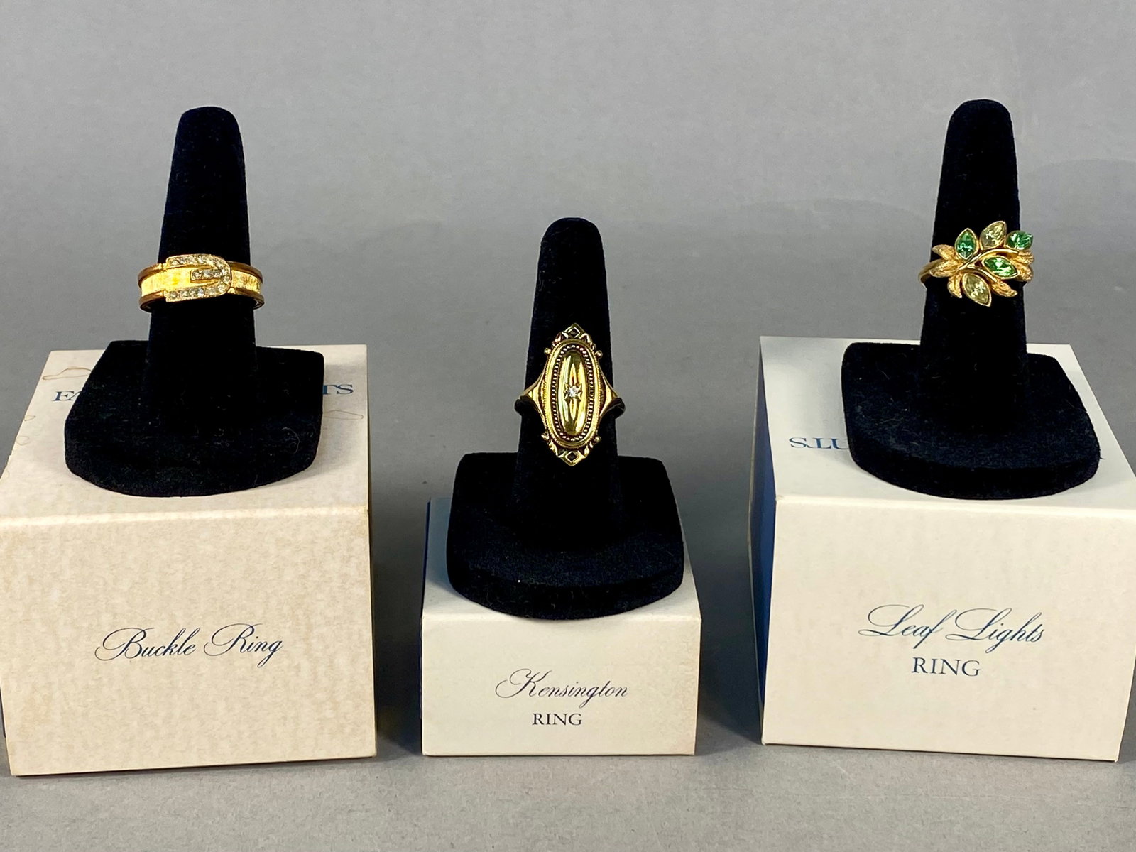 Three Vintage Avon Costume Rings: This lot comprises three gold-toned base metal costume rings produced by Avon Products, Inc., between 1973 and 1976. Each piece is accompanied by its original Avon Fashion Accents in Jewelry presentat