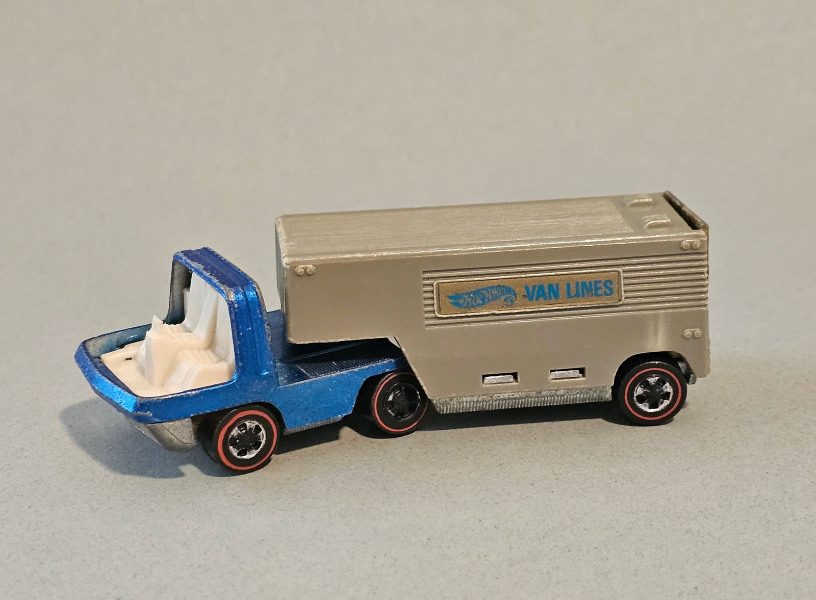 Hot Wheels Redline Moving Van: This vintage Hot Wheels toy truck set is part of the original Heavyweights series manufactured by Mattel, Inc. The set includes a die-cast metal cab and a corresponding plastic trailer. 1969 Measureme