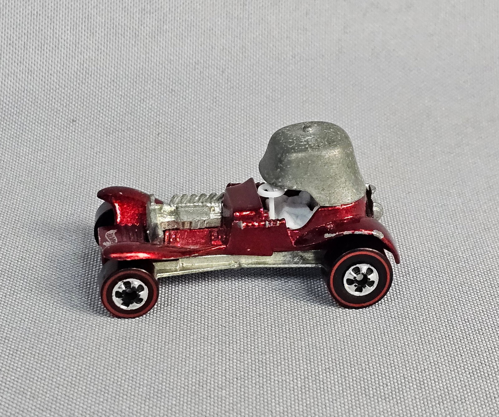 Mattel Hot Wheels Red Baron: This Mattel Hot Wheels Red Baron is a die-cast metal toy vehicle from the Vintage Series reissue collection. The car features a metallic red finish with a die-cast metal base. 1969. Length: 2 inches. 