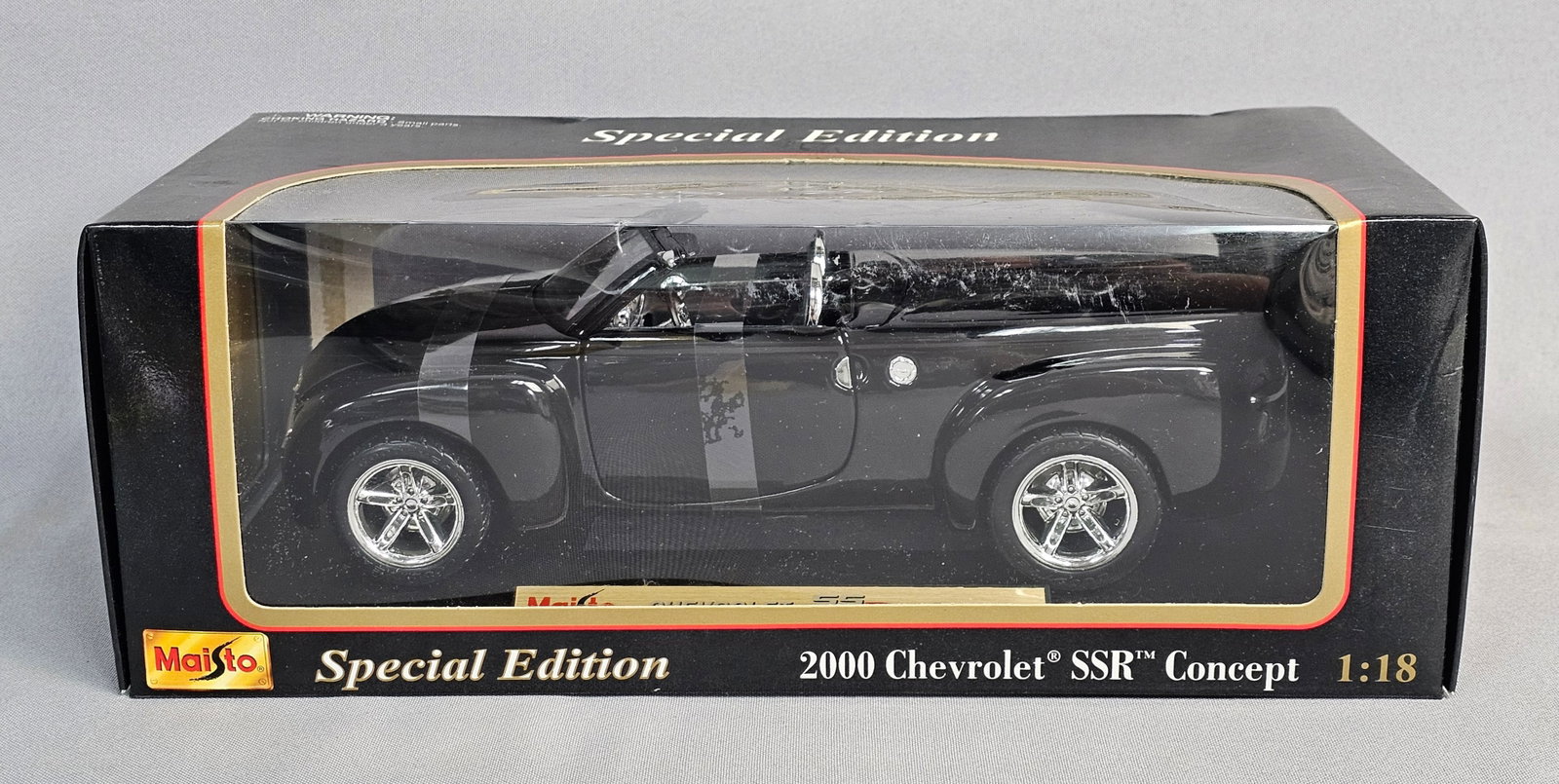 Maisto 2000 Chevrolet SSR Concept Model Car: A Maisto Special Edition die-cast model car representing the 2000 Chevrolet SSR Concept in 1:18 scale. The vehicle is finished in gloss black and features chrome-finished wheels and interior accents. 