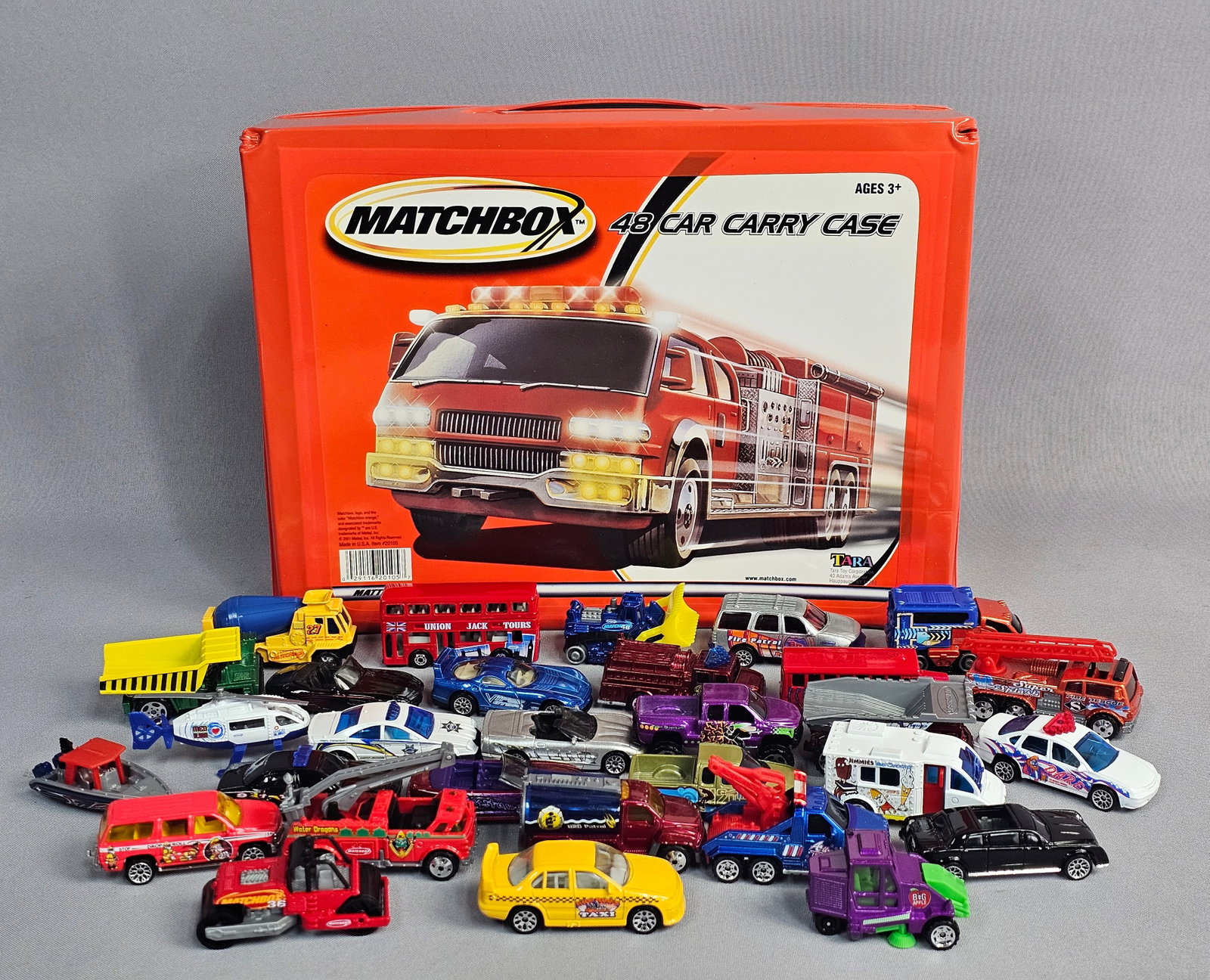 Collection of Toy Vehicles and a Car Carry Case: This collection consists of approximately 27 toy vehicles and an associated carrying case. The carrying case is a Matchbox 48 Car Carry Case, manufactured by Tara Toy Corp. under license from Mattel, 