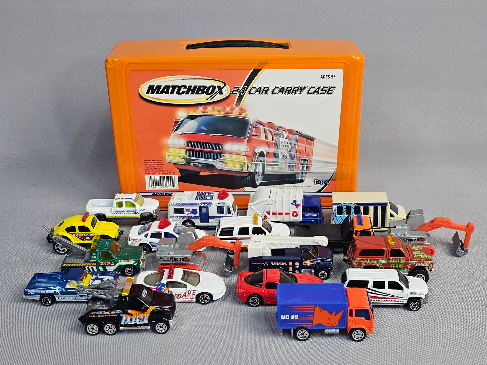 Matchbox Carry Case with Assorted Vehicles: This lot features an orange vinyl-covered Matchbox 24-car carry case manufactured by Tara Toy Corporation, containing approximately 18 assorted die-cast and plastic vehicles. Case measures 10 x 7 inch