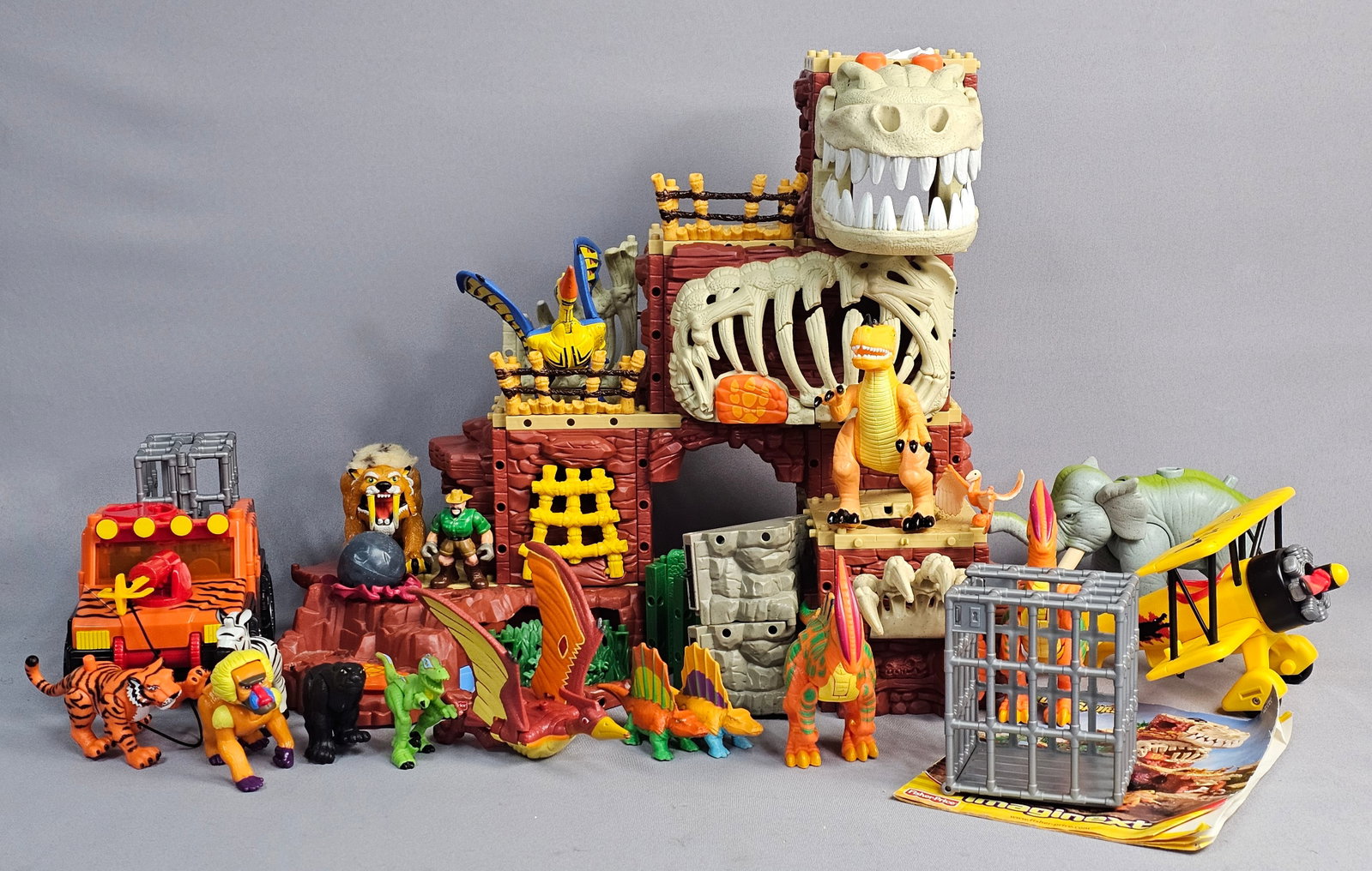 Fisher-Price Imaginext Playset Components and Figures: This is a modular prehistoric-themed playset lot manufactured by Fisher-Price, a division of Mattel. The primary structure is the T-Rex Mountain, model H5341, as identified on the included instruction