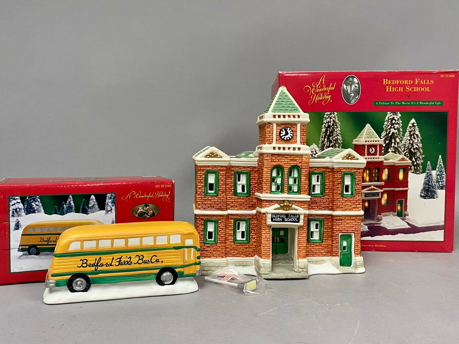 Two It's a Wonderful Life Ceramic Village Pieces: This lot consists of two porcelain collectible pieces from the A Wonderful Holiday collection by DHC, produced in 1996 and themed after the film It's a Wonderful Life. Included is the Bedford Falls
