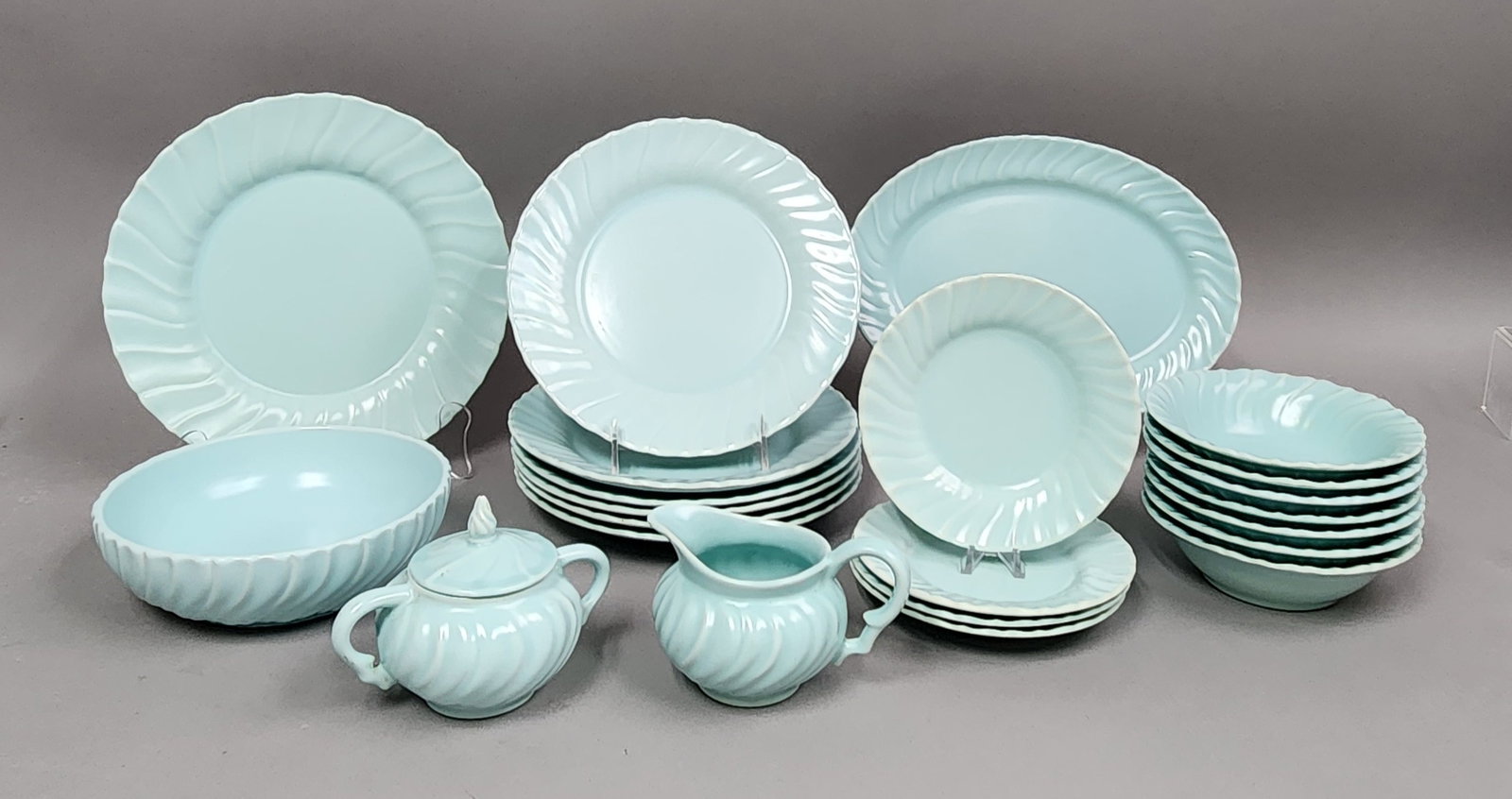 Franciscan Coronado Earthenware Dinnerware: This 21-piece set of American earthenware dinnerware is from the Franciscan Coronado line, featuring a characteristic molded swirl pattern and a monochromatic aqua matte glaze. The set was produced by