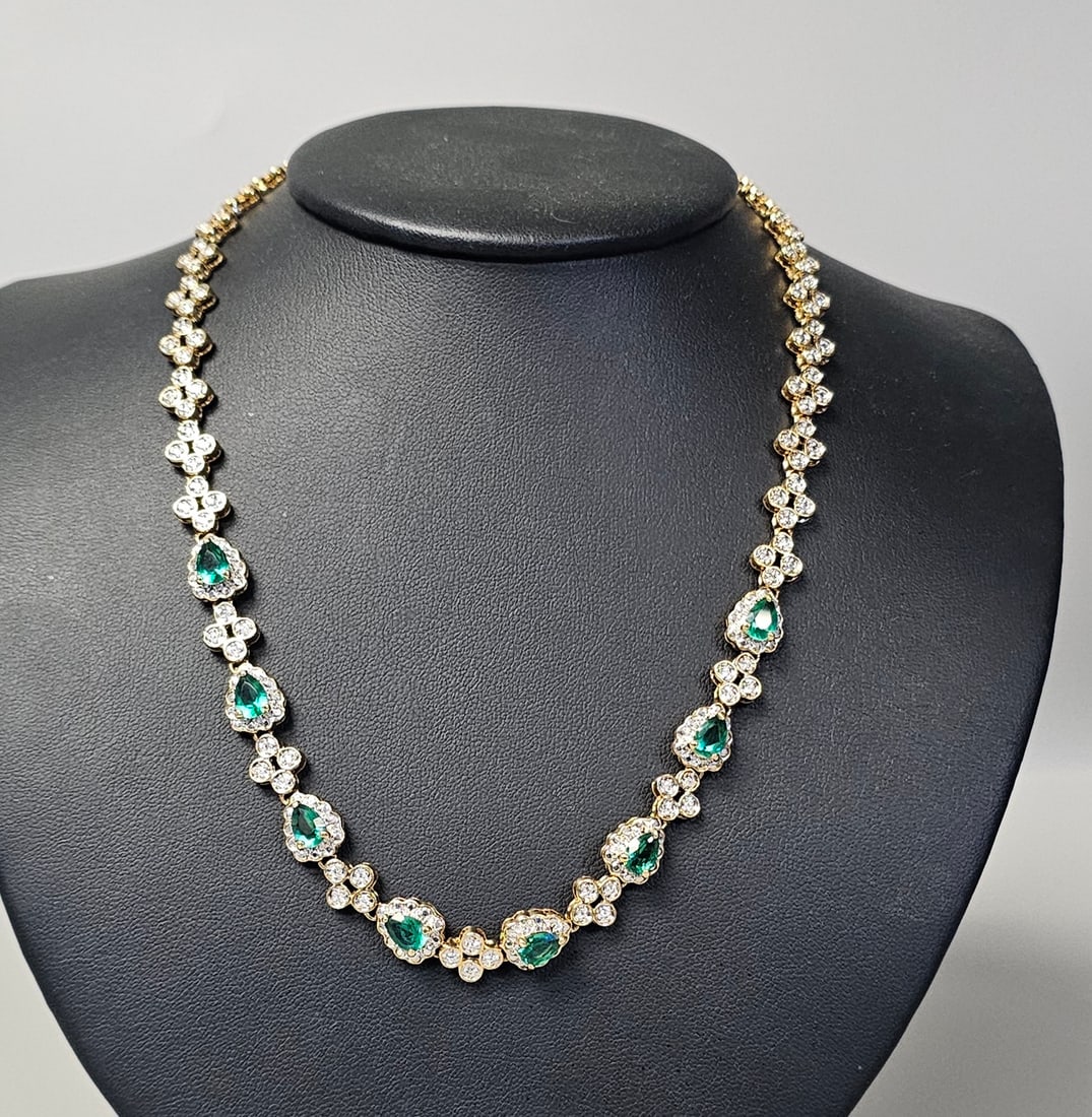 Camrose Cross Jackie Kennedy Crystal Necklace: This gold plated necklace is a piece from the Jacqueline Bouvier Kennedy collection by Camrose & Kross. The design features seven pear-cut green simulated emeralds, each surrounded by a halo of clear