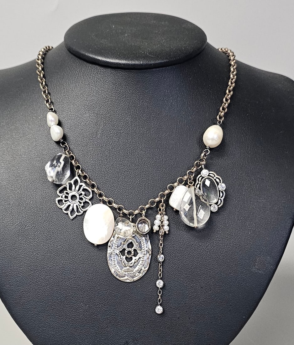 Silpada Sterling Silver Charm Necklace 34.1 Grams: This Silpada Brand sterling silver charm necklace features an oxidized rolo link chain supporting an eclectic assortment of dangles. The necklace includes two large white mother-of-pearl cabochons, on