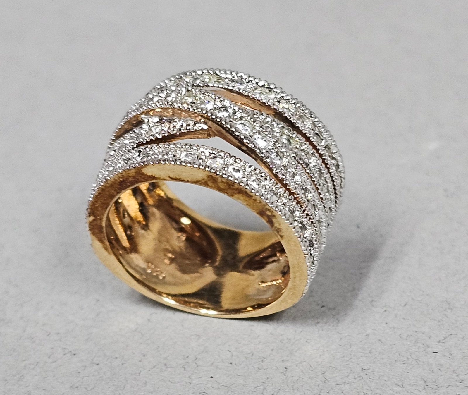 Sterling Gilt Pave-Set Clear Stone Ring 7.6 Grams: A wide multi-band cocktail ring crafted in yellow gold-plated sterling silver. The modern design features five horizontal bands, with the three middle bands overlapping in a criss-cross pattern at the