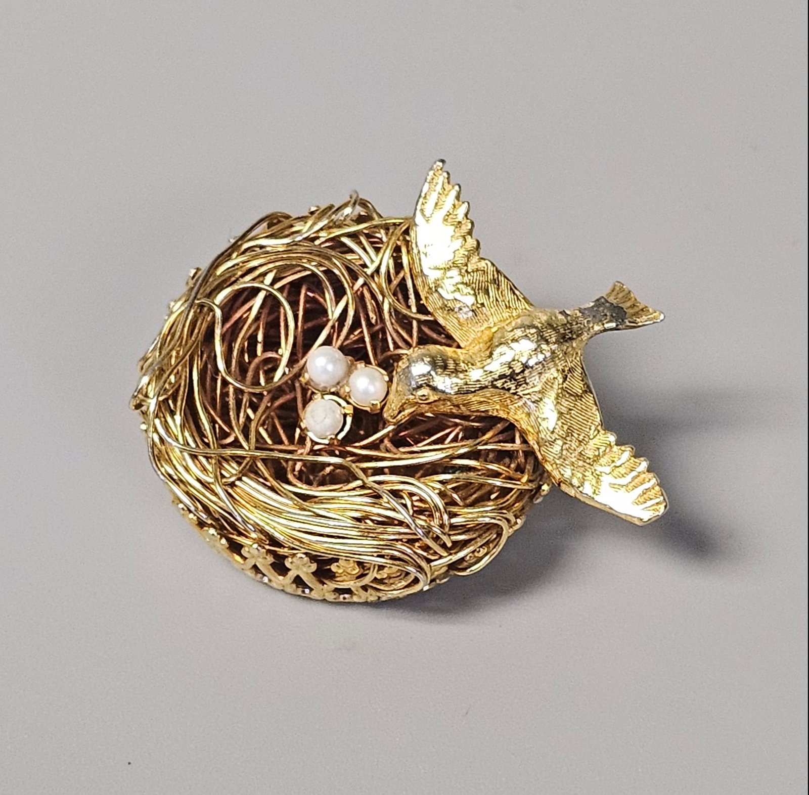 Vintage Jeanne Bird on Wire Nest Brooch: This vintage costume jewelry brooch is a design by Jeanne. Three small white faux pearls representing eggs are nestled within the wire structure. The reverse of the brooch is fitted with a horizontal