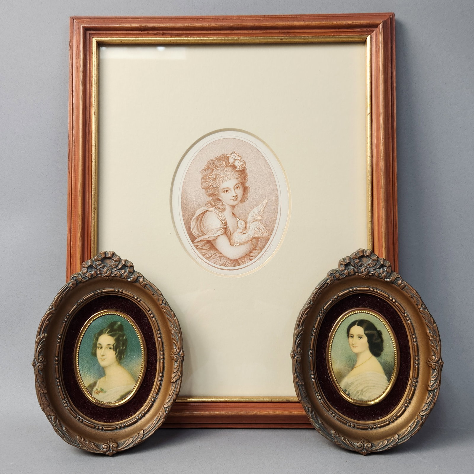 Trio Of Portrait Prints: The larger print is a sepia-toned stipple engraving depiction of a young woman with curly hair holding a dove. The print features the printed inscription Edwin Roffe, sculp. along the upper right marg