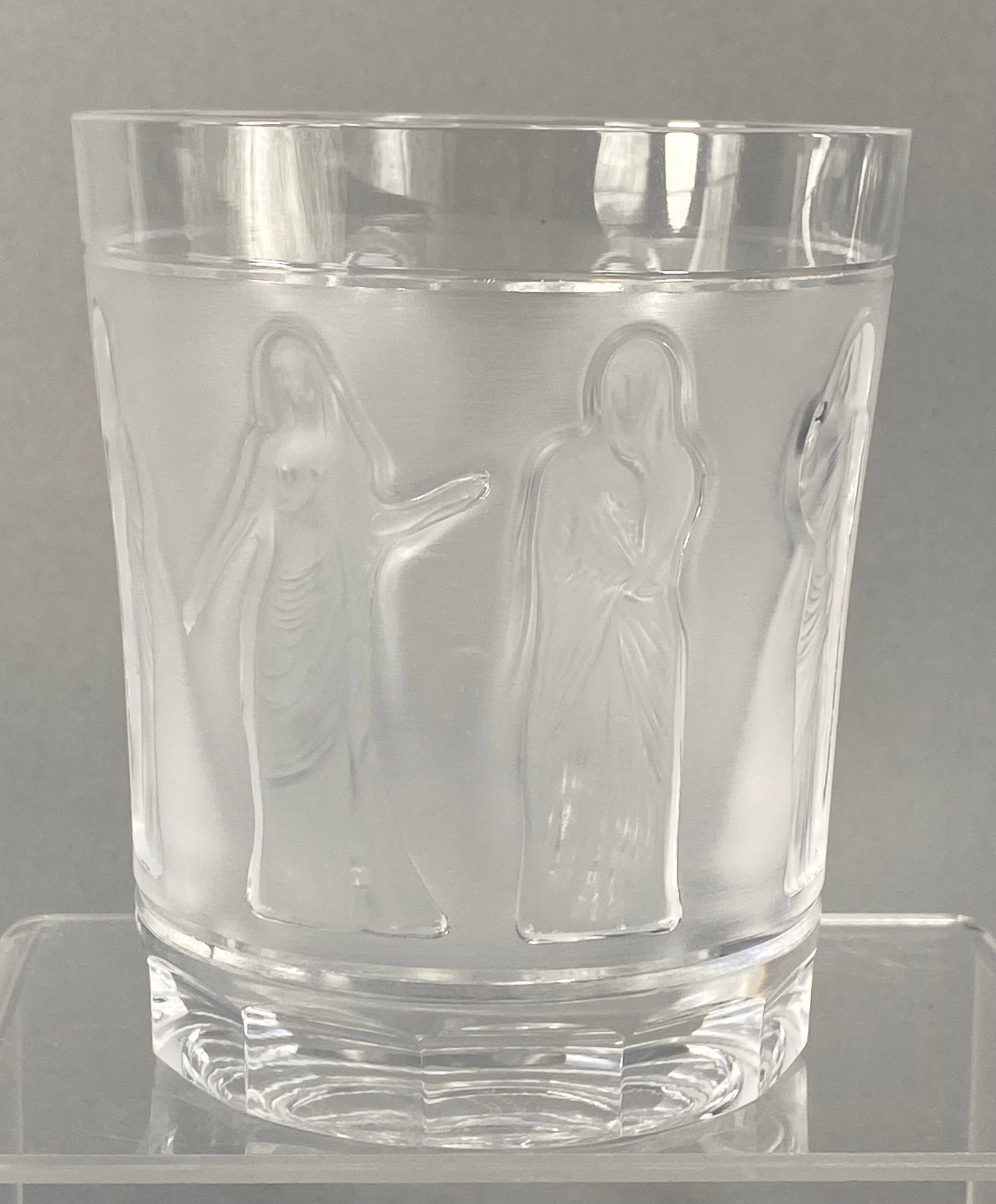 Lalique French Crystal Femmes Antiques Tumbler: A French lead crystal whiskey tumbler manufactured by Lalique in the Femmes Antiques pattern. The vessel features a wide, frosted central band decorated with high-relief figures of classical draped