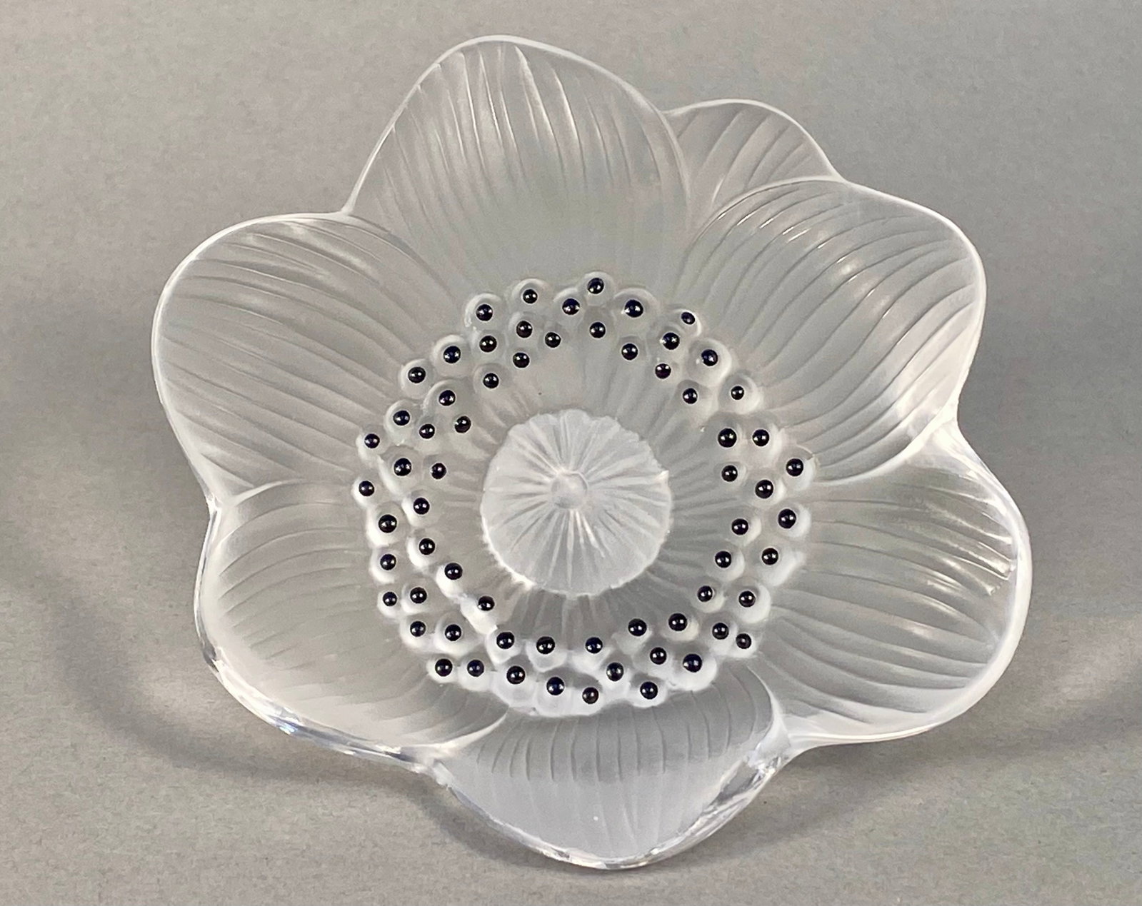 Lalique France Frosted Crystal Anemone Flower: This molded crystal decorative object is the Anemone design by Lalique, France. The piece is modeled as a single flower blossom with six overlapping petals. The petals feature a frosted texture with
