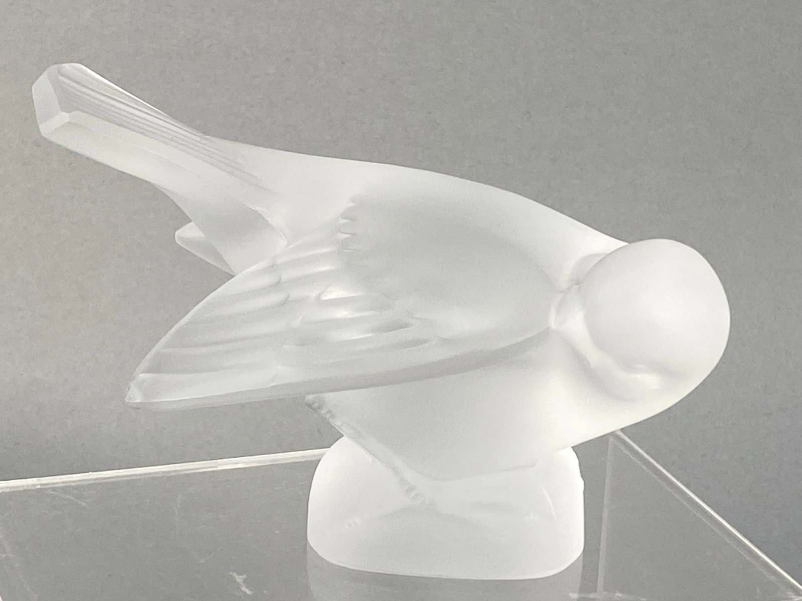 Lalique France Frosted Crystal Moineau Coquet Sparrow: A frosted crystal glass figurine of a sparrow, identified as the Moineau Coquet model, produced by Lalique France. The piece depicts a bird in a leaning, pecking posture with stylized feathering on