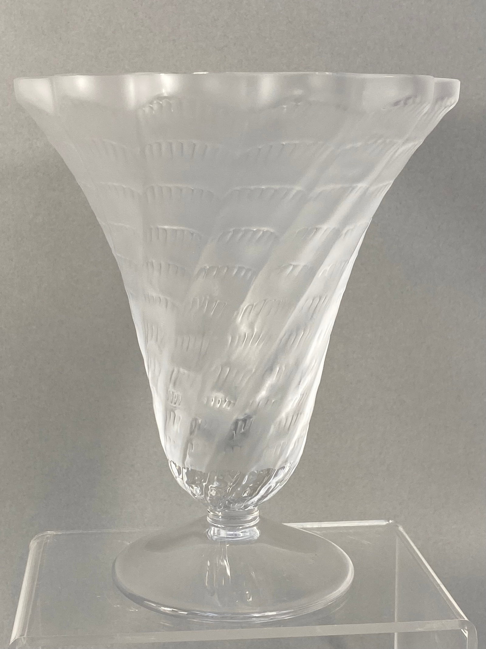 Lalique France Lucie Frosted & Clear Glass Vase: A Lalique glass vase in the Lucie pattern, featuring a flared conical form with a scalloped rim. The exterior is decorated with an all-over pattern of spiraling, overlapping stylized leaf motifs in a