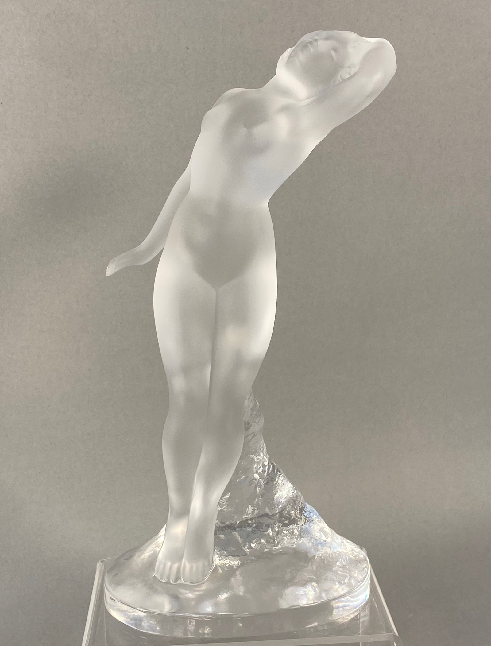 Lalique France Crystal Naiade Nude Dancer Figurine: A Lalique France crystal figurine known as the Naiade or Nude Dancer. The piece is sculpted from lead crystal and depicts a nude female figure in a dynamic, arched pose with arms raised behind her