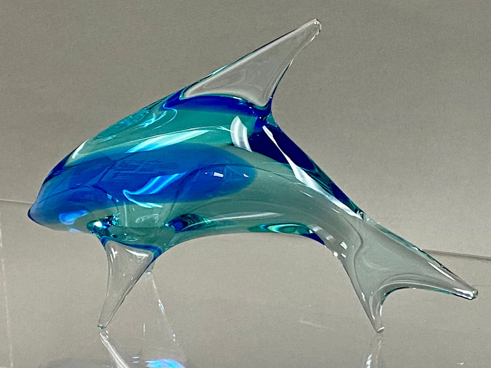 Mid-Century Sommerso Art Glass Dolphin Sculpture: A stylized art glass sculpture of a dolphin, attributed to Czech glass artist Miloslav Janku. The piece is executed in the sommerso technique, featuring a core of deep cobalt blue encased in a lighter