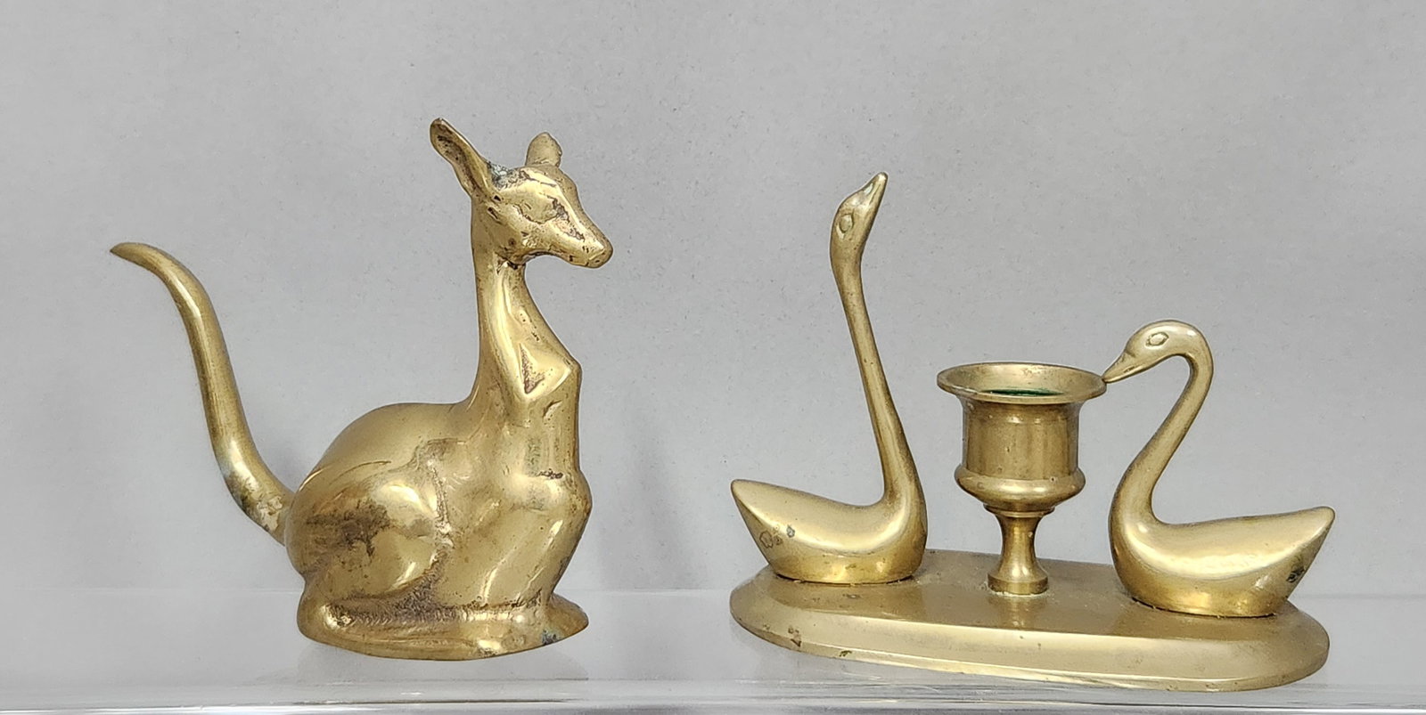 Mid-Century Cast Brass Animal Figures: This lot includes two cast brass decorative objects featuring stylized animal forms. Kangaroo: 4.75 in. (H) x 5 in. (L) Candlestick holder: 4.25 in. (H) x 6 in. (W). Both items are in good vintage con