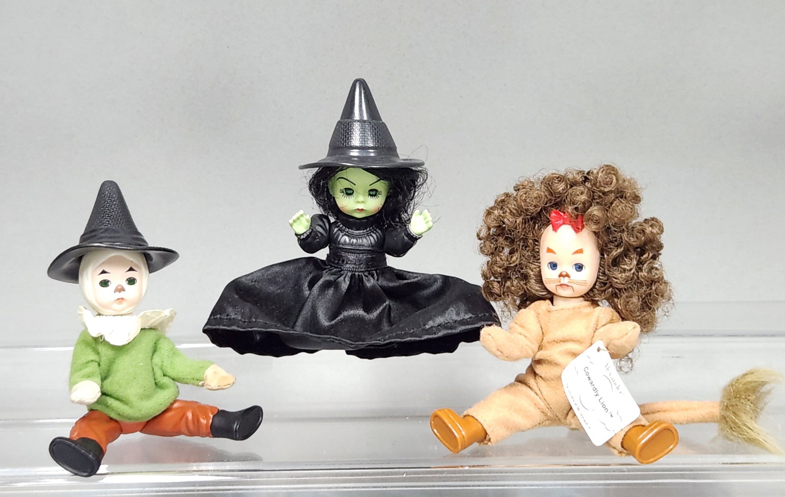 Madame Alexander Wizard of Oz Dolls: A set of three Madame Alexander promotional vinyl dolls produced exclusively for McDonald's Corporation, featuring characters from The Wizard of Oz. The Cowardly Lion retains its original paper hangta