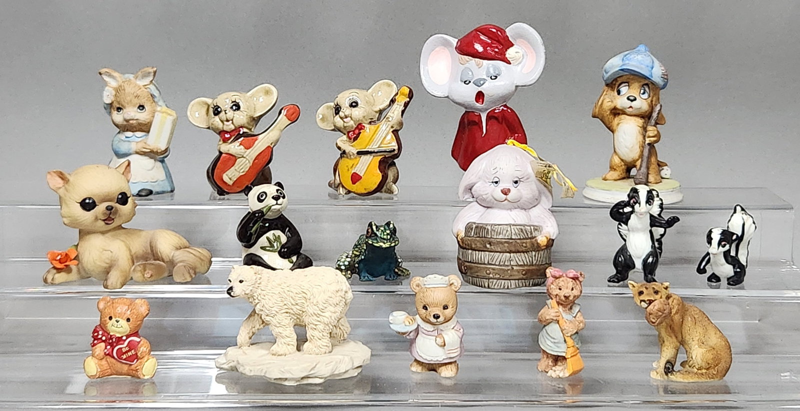 Animal Figurines Inc Bronson Collections: This lot consists of 15 animal figurines in varied styles and materials. Heights range from approximately 1 inch to 3.5 inches. Generally good condition. A minor chip is noted on one of the petals of 