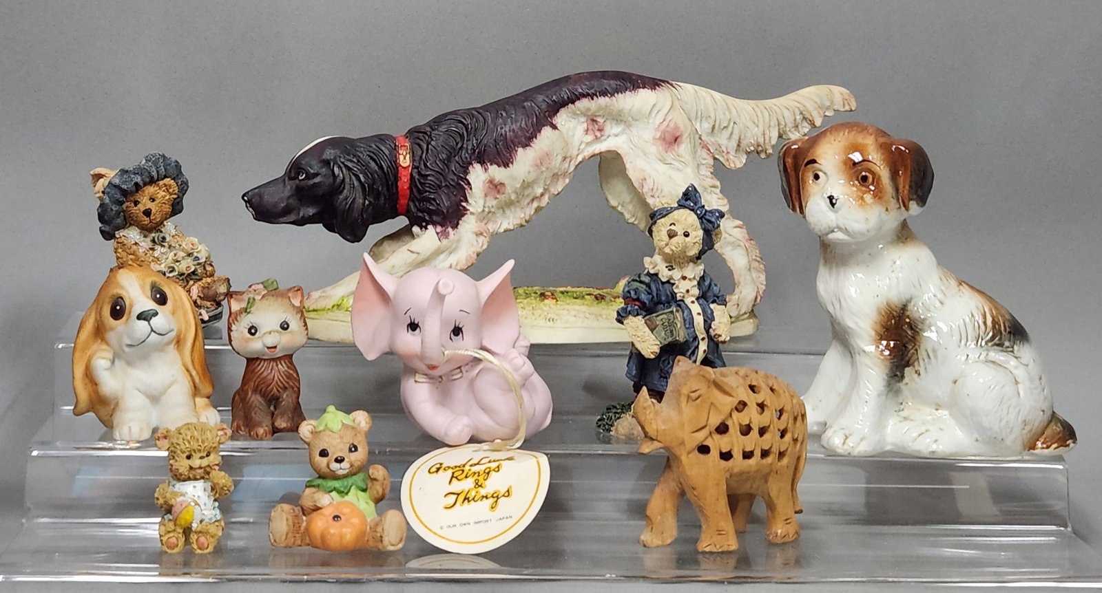 Ceramic and Resin Animal Figurines: An assortment of animal figurines crafted from various materials including ceramic, bisque, resin, and carved stone. Large Pointer Dog: 10 inches in length Sitting Puppy: 5.5 inches in height Bears: 1