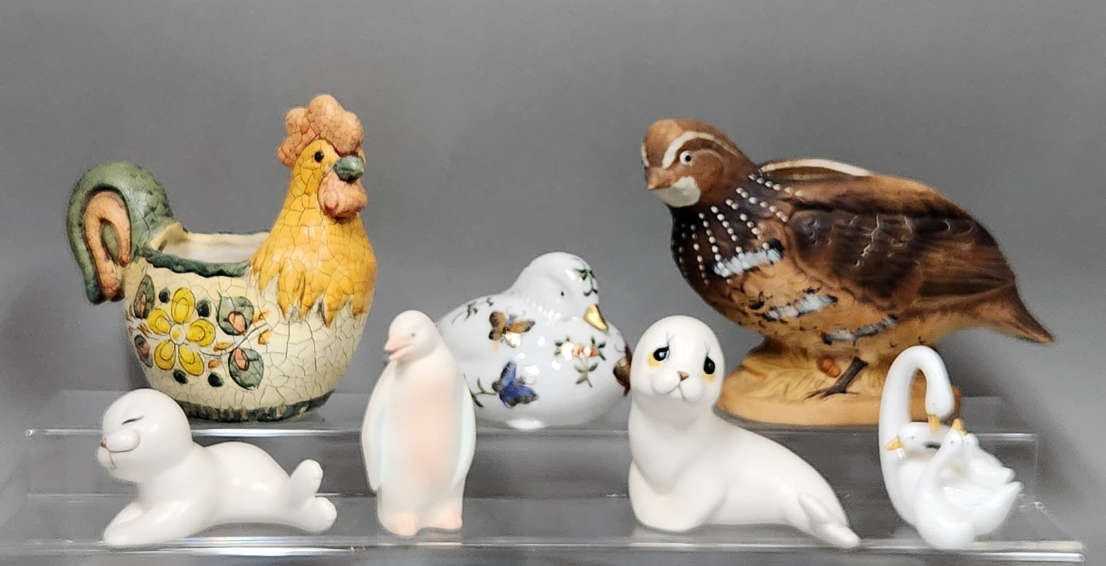 Collection Animal Figurines & Planters: This lot features a collection of ceramic and porcelain animal-themed items. Rooster Planter Height: Approximately 5 inches Quail Planter Height: Approximately 5.5 inches Bird Figurine Length: Approxi