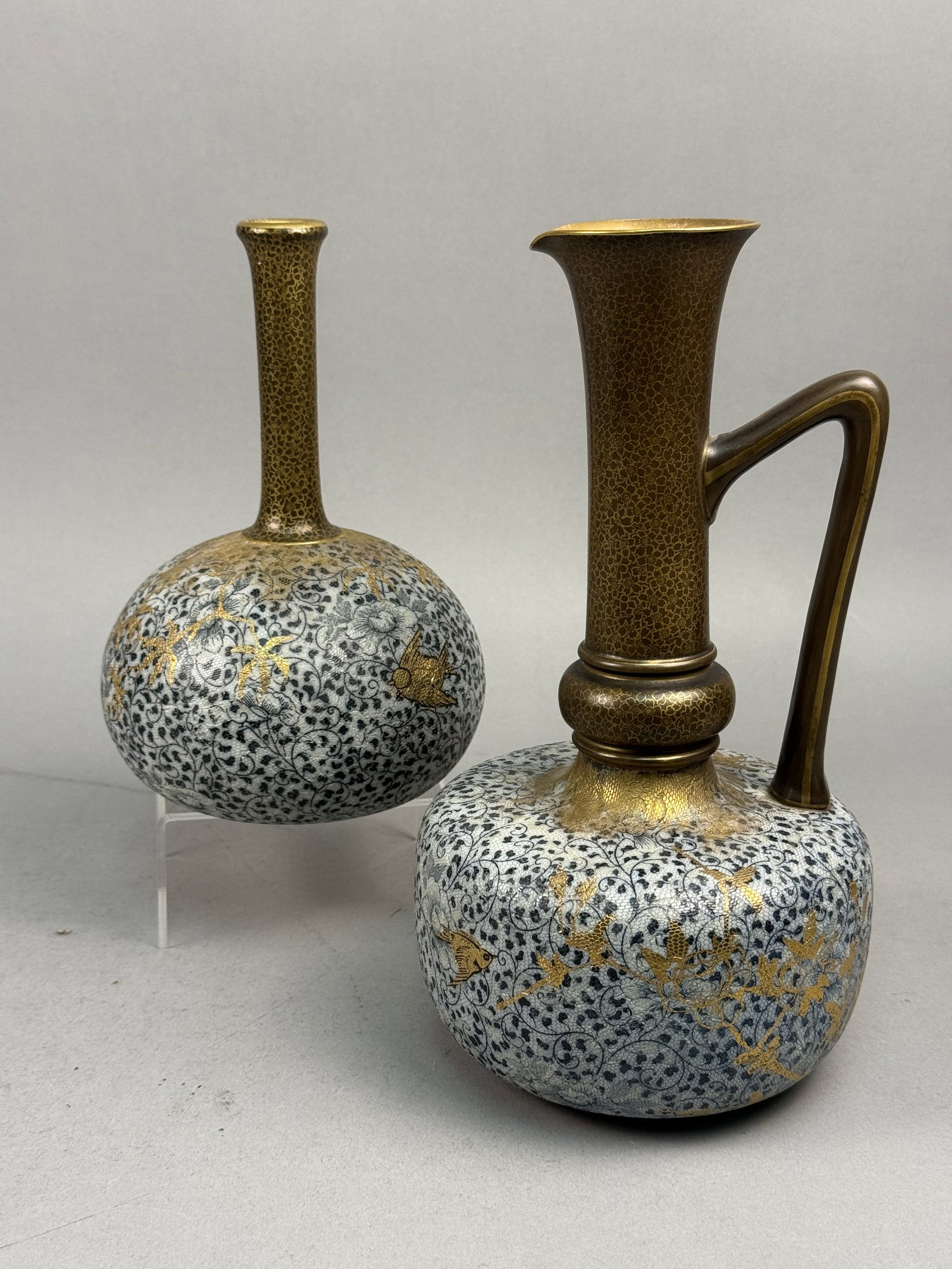 Doulton & Slater Patent Aesthetic Movement Ceramic Vessels: A set of two Doulton Burslem earthenware vessels consisting of one bottle-shaped vase and one handled ewer with a flared spout. The pieces are decorated using the Doulton and Slater Patent technique,