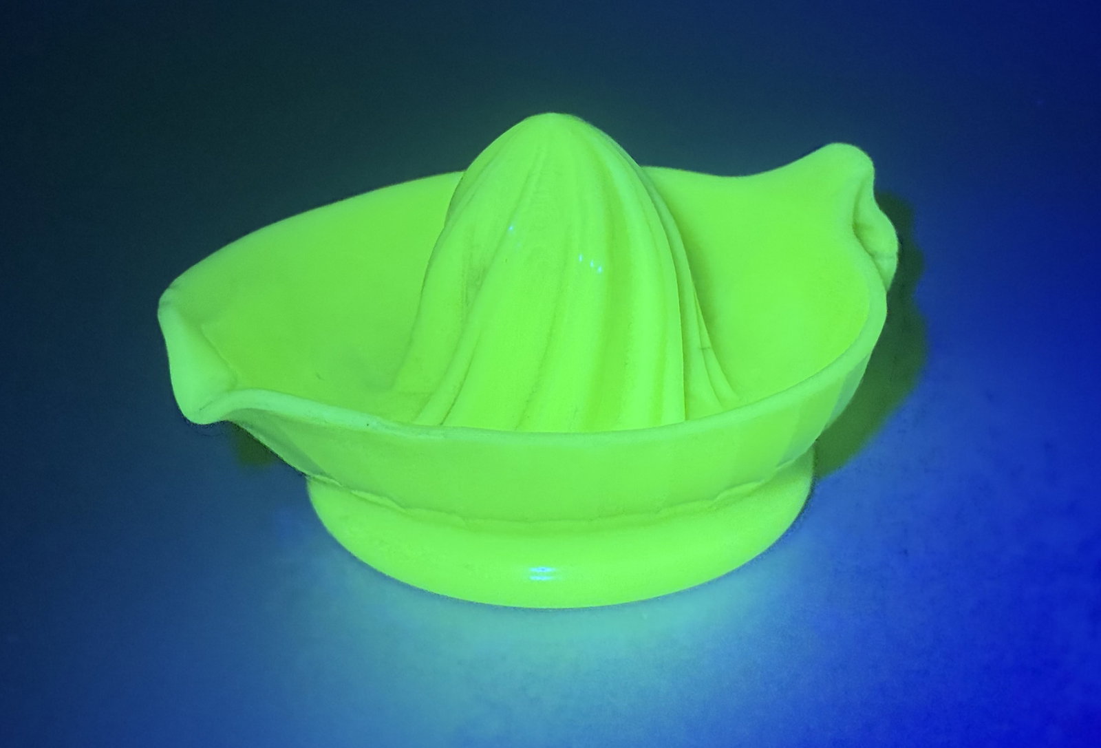 Vintage Uranium Jadeite Citrus Juicer: A vintage pressed glass citrus juicer, or reamer, attributed to the McKee Glass Company. The piece is constructed from opaque mint green glass, characteristic of the Jadeite or Custard glass styles pr