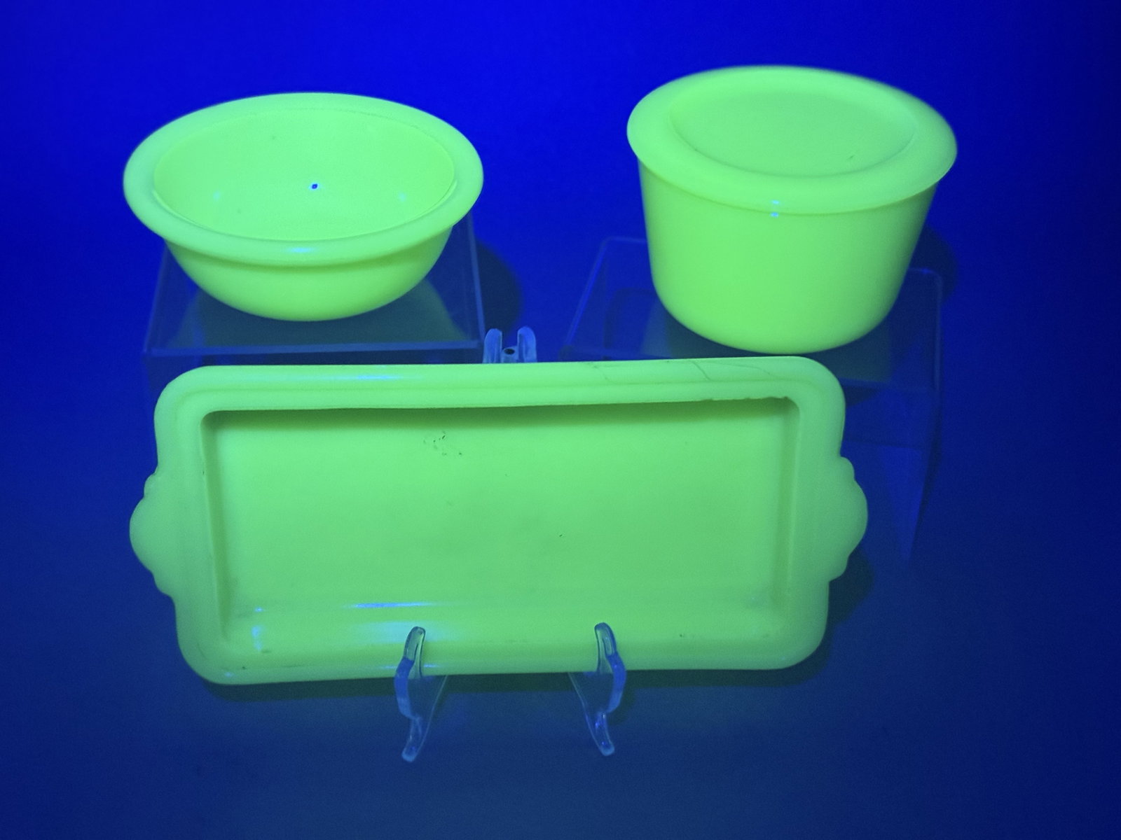 McKee Jadeite Uranium Glass Kitchenware: This set of opaque green kitchenware was manufactured by the McKee Glass Company. The items are made of Jadeite glass, often referred to as Skokie Green, which contains uranium and exhibits a bright g
