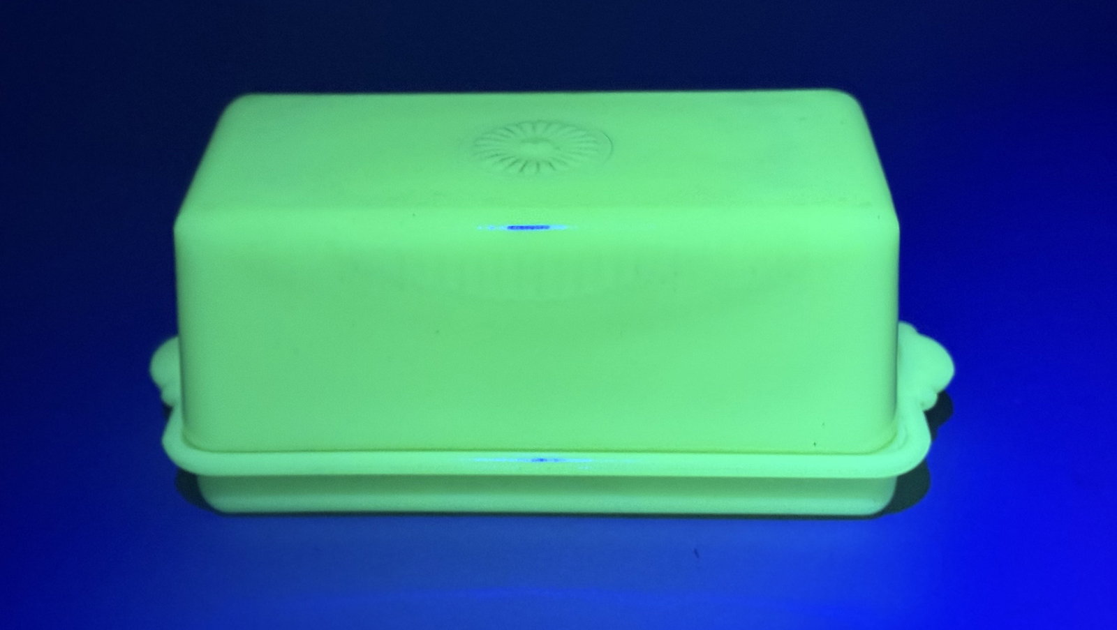 McKee Glass Jadeite Uranium Glass Butter Dish: This is a mid-20th-century pressed uranium glass butter dish with a matching cover, produced by the McKee Glass Company. The underside of the base features an embossed circular mark containing the