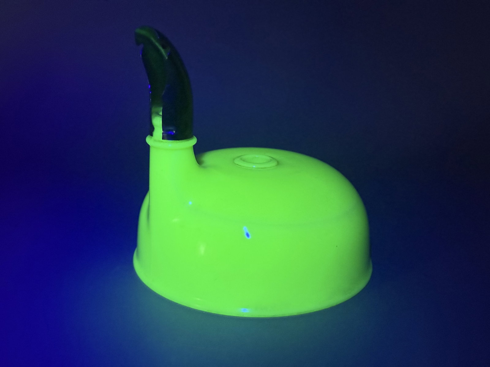 Jadeite Uranium Glass Mixer Bowl Attachment: The piece is crafted from jadeite uranium glass, which exhibits a bright neon green fluorescence when exposed to ultraviolet light. The lid features a domed profile with a central hole and an offset