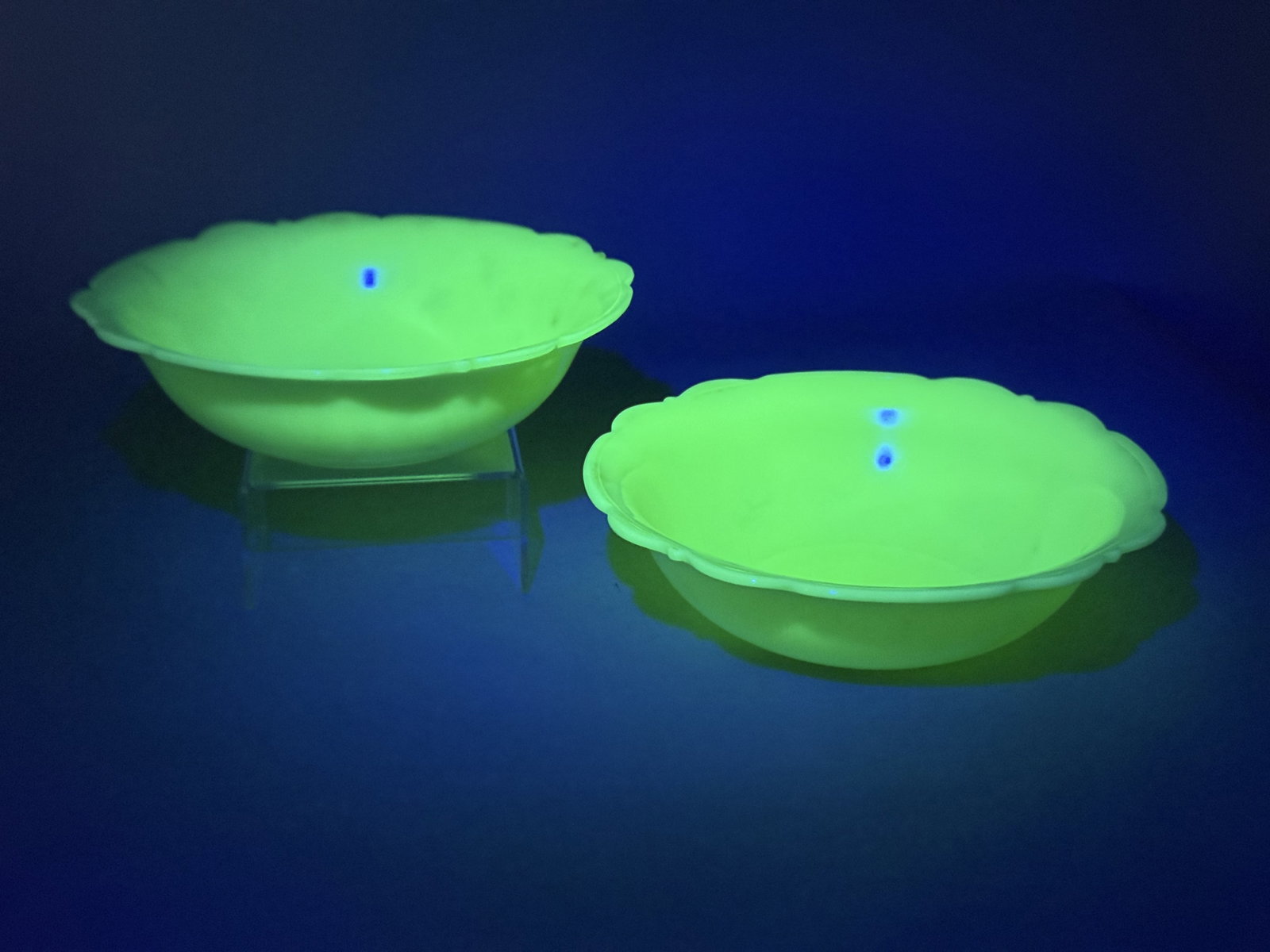 McKee Glass Jadeite Uranium Glass Bowls: This lot features a pair of vintage pressed glass bowls manufactured by the McKee Glass Company. The bowls are crafted from opaque light green jadeite glass. The presence of uranium in the glass compo