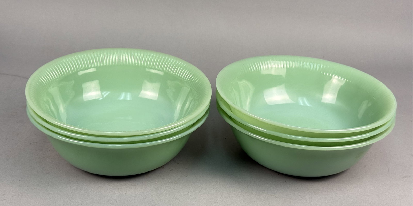 Fire-King Jadeite Jane Ray Pattern Dessert Bowls: A set of six vintage opaque pale green glass dessert or berry bowls. These pieces are executed in the Jane Ray pattern, which is defined by a distinctive reeded or ribbed design around the interior
