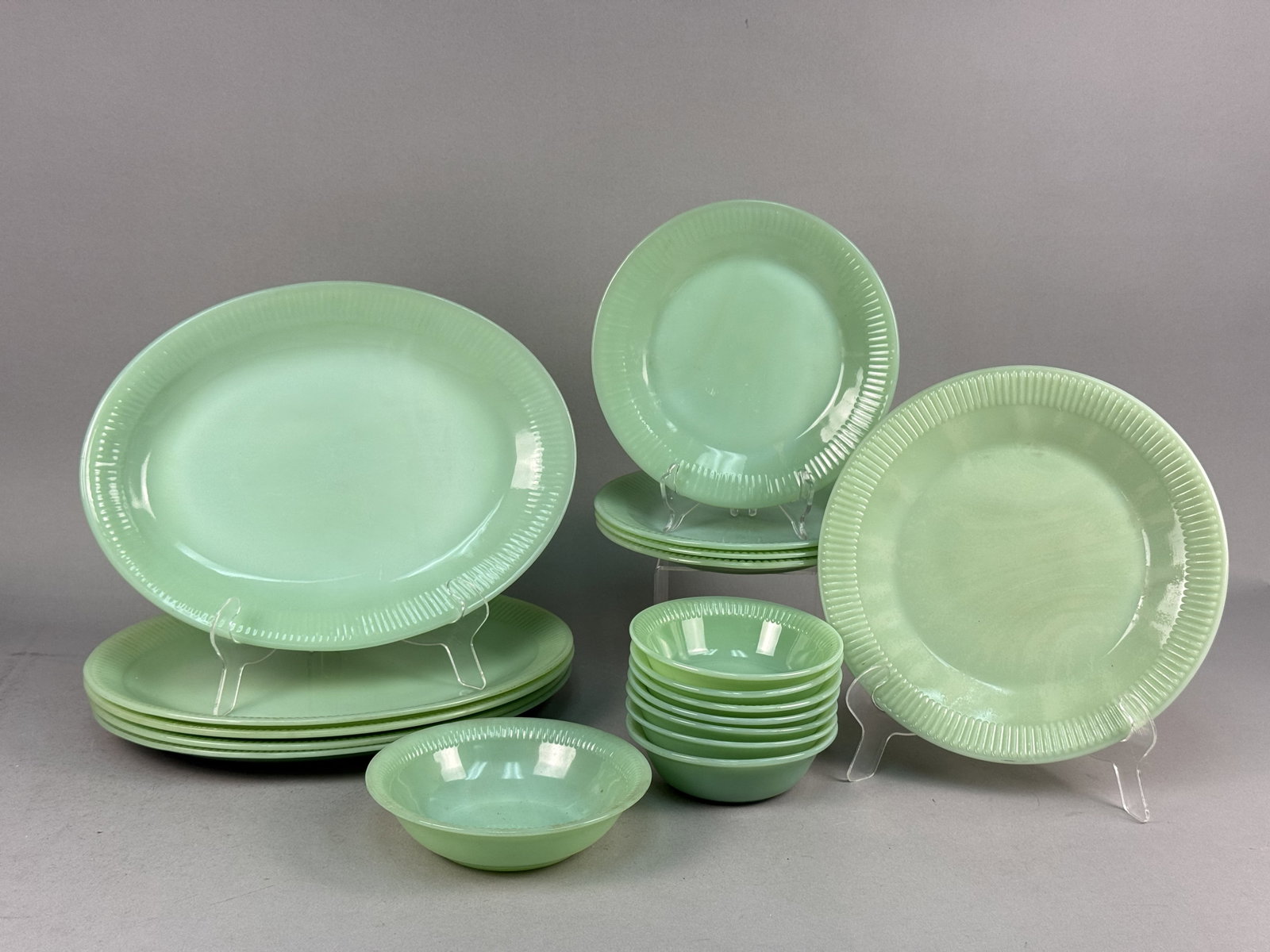 Fire-King Jadeite Jane Ray Pattern Mixed Set: This 18-piece dinnerware set is manufactured by Fire-King in the Jane Ray pattern, dating to the mid-20th century. The collection is made of opaque sea-green glass, commonly referred to as Jadeite,