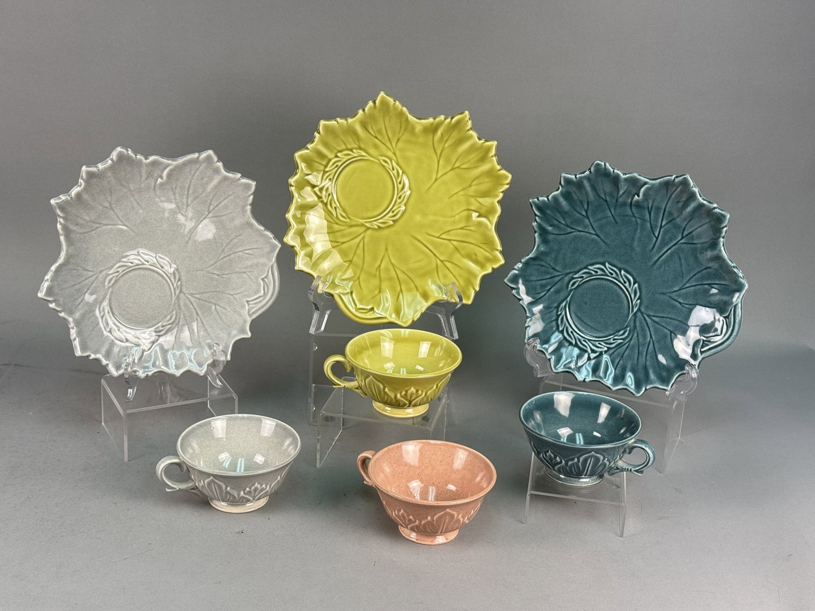 Steubenville Woodfield Pattern Snack Plates & Cups: This collection of American earthenware is in the Woodfield pattern, produced by the Steubenville Pottery Company of Steubenville, Ohio. The assortment features a naturalist molded leaf design with va