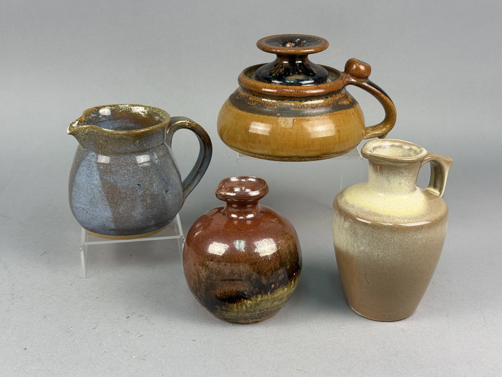 Art & Studio Pottery Incl Frankoma and Red Duck: This collection features several varied ceramic vessels representing both production art pottery and independent studio work. Included is a small Frankoma Pottery pitcher or ewer, mold number 338, fea