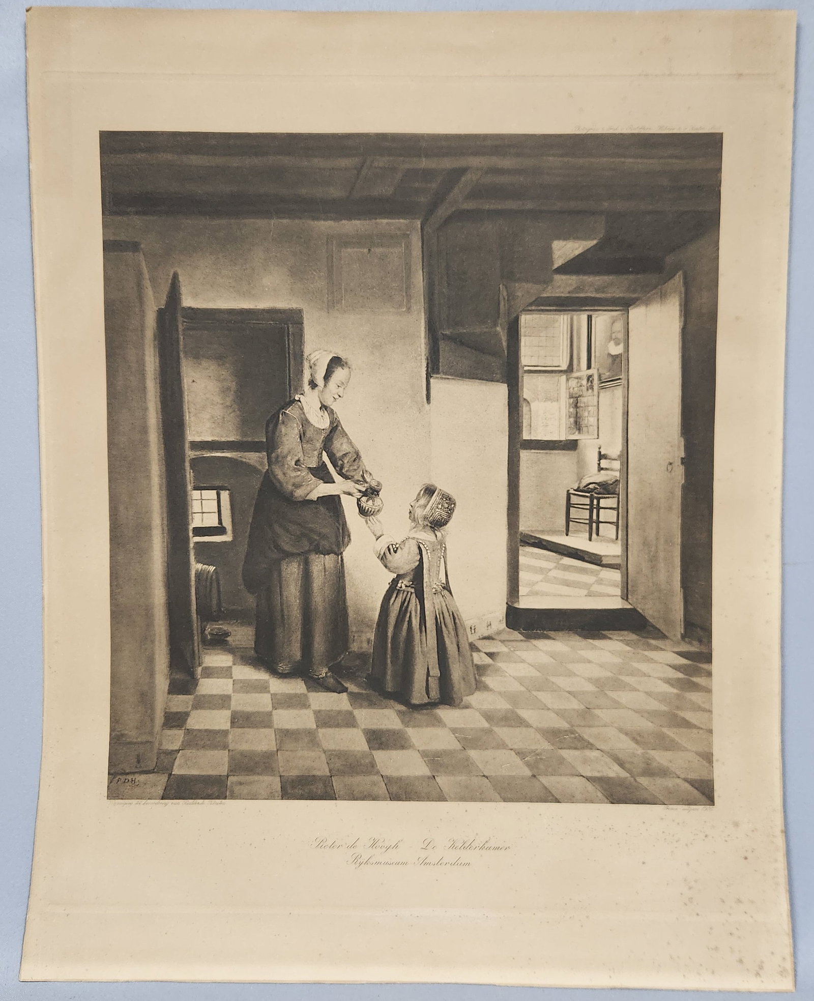 The Buttery After Pieter de Hooch De Kelderkamer: A 1916 monochrome photogravure print on paper reproducing Pieter de Hooch's De Kelderkamer, published by Roeloffzen, H??bner and van Santen, measuring approximately 28 by 22 inches. Print is in fair
