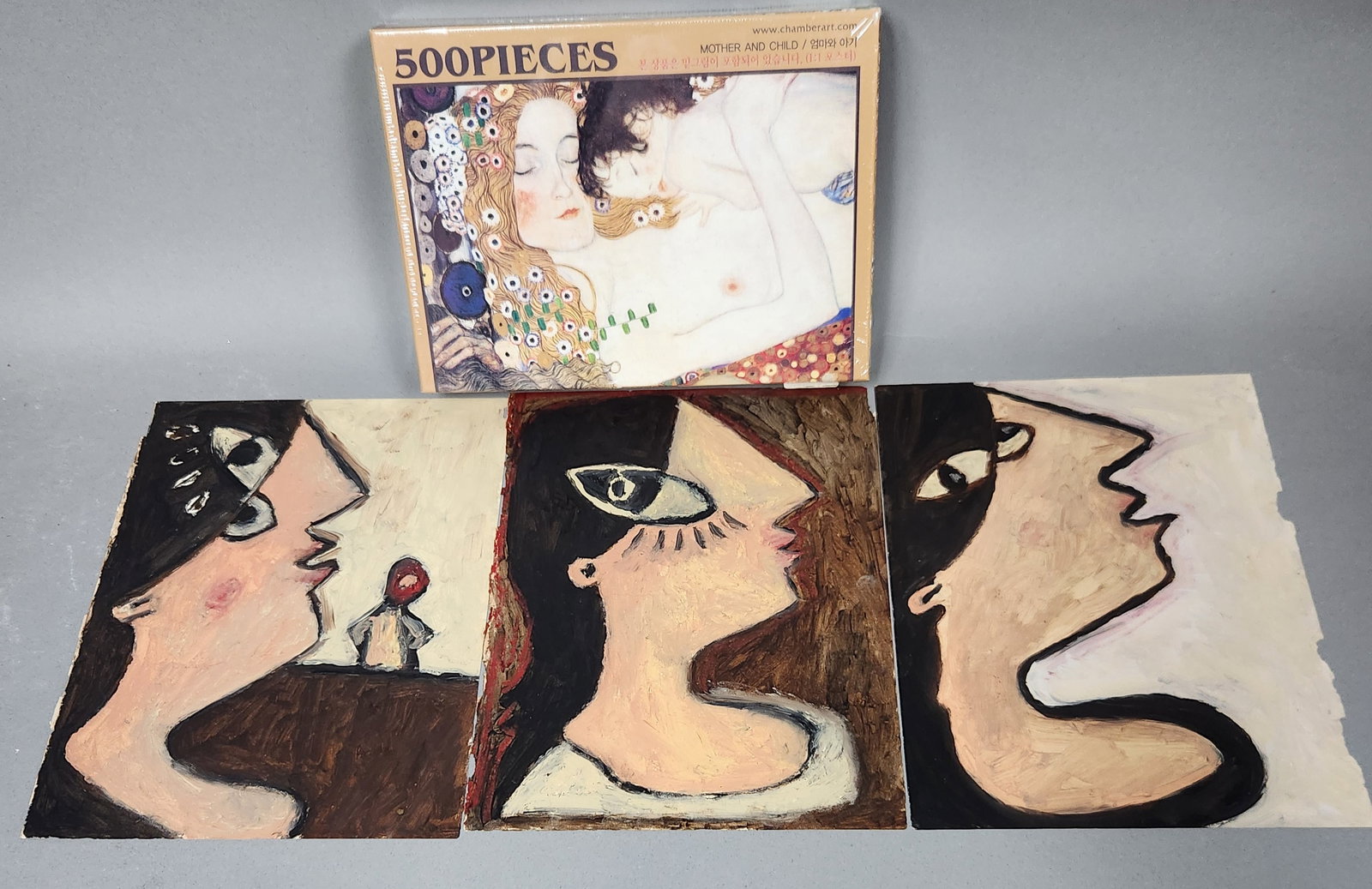 Modernist Profile Studies & Sealed Jigsaw Puzzle: This lot consists of a collection of items including three unframed modernist paintings and one factory-sealed jigsaw puzzle. The three paintings are executed in a heavy impasto medium, likely oil or 