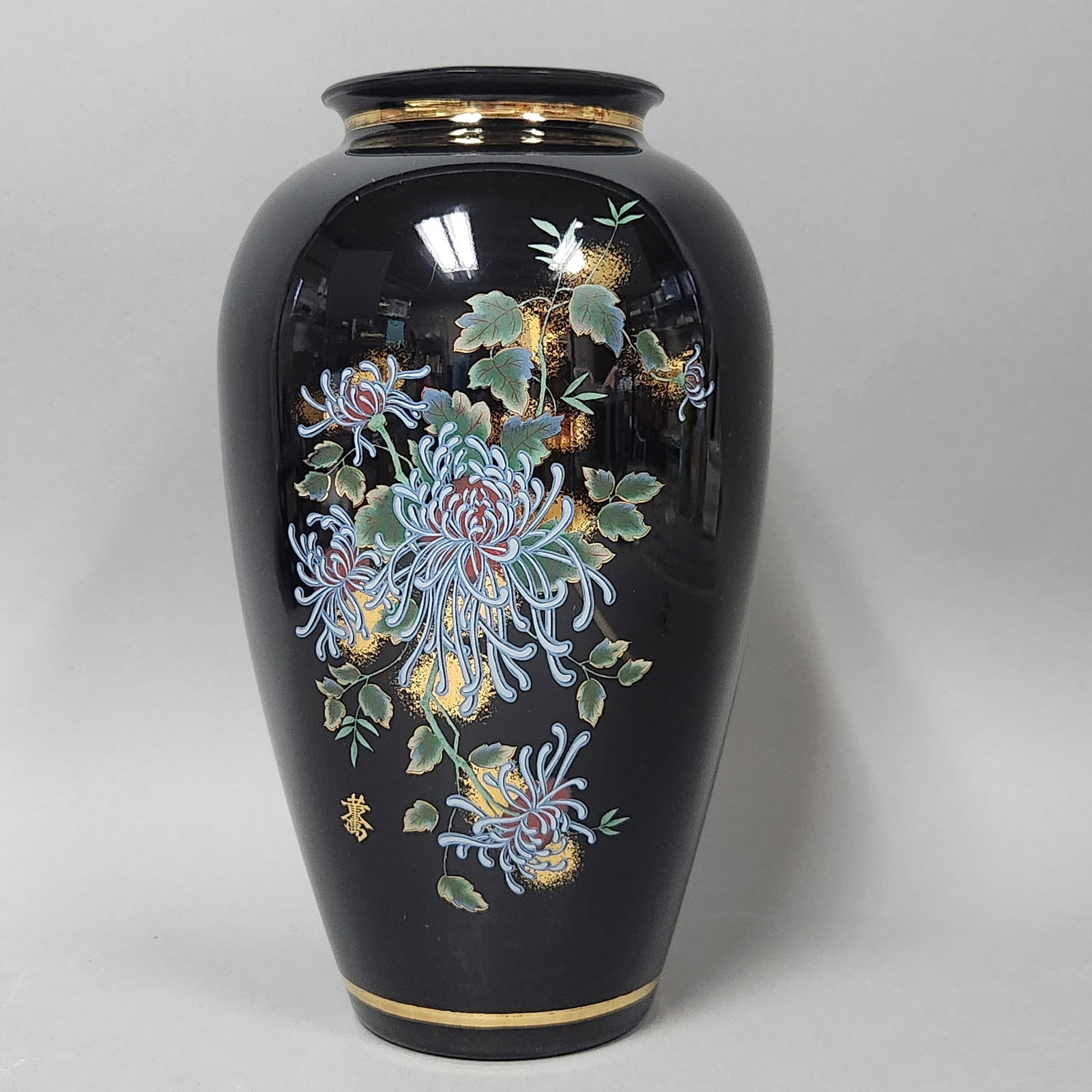 Japanese Porcelain Ovoid Vase: A large Japanese porcelain vase of ovoid form featuring a high-gloss black enamel glaze ground. The underside of the base features a faint circular stamp and the word JAPAN in block letters. Height:
