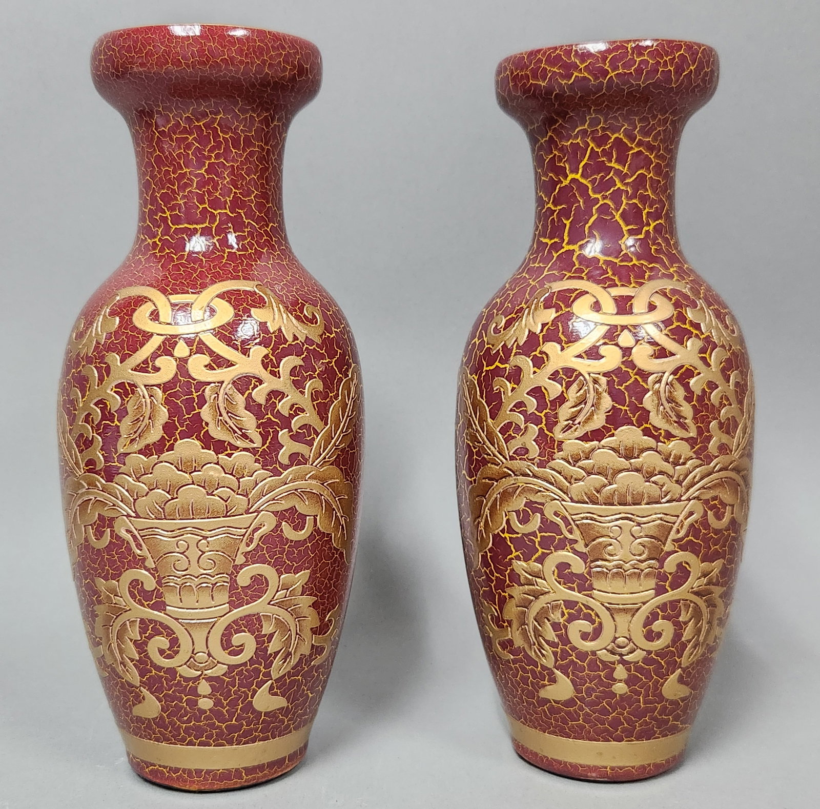 Chinese Red Crackle & Gilt Vases: A pair of decorative ceramic vases of baluster form, each featuring a bulbous body, a tapering neck, and a flared rim. Dimensions: Each vase measures approximately 11.75 inches in height. Both vases a