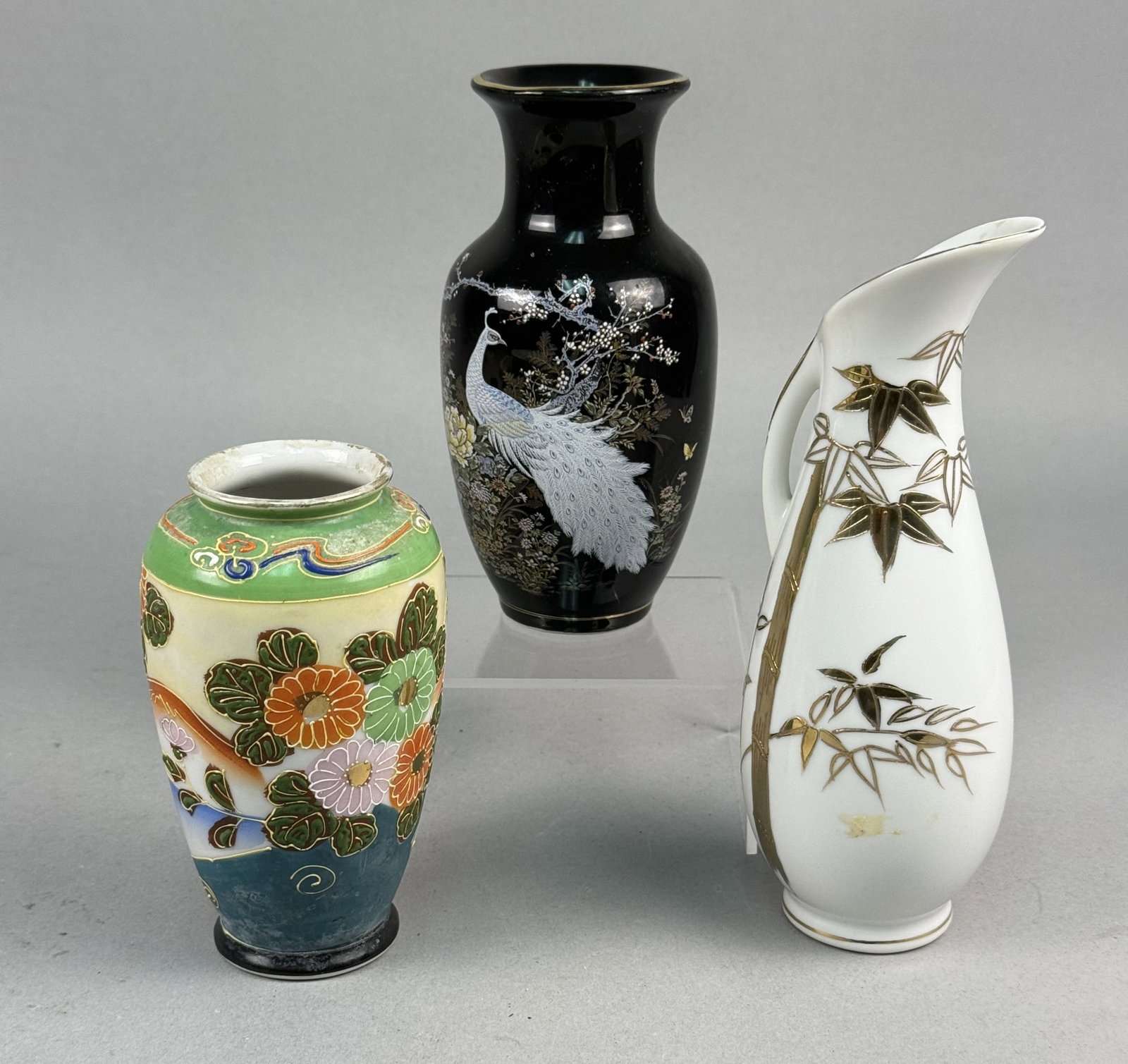 A Trio of Japanese Ceramic and Porcelain Vessels: A trio of Japanese ceramic and porcelain vessels produced for the export market in the mid-to-late 20th century. The collection includes a Satsuma style earthenware vase, a Shibata porcelain vase, and