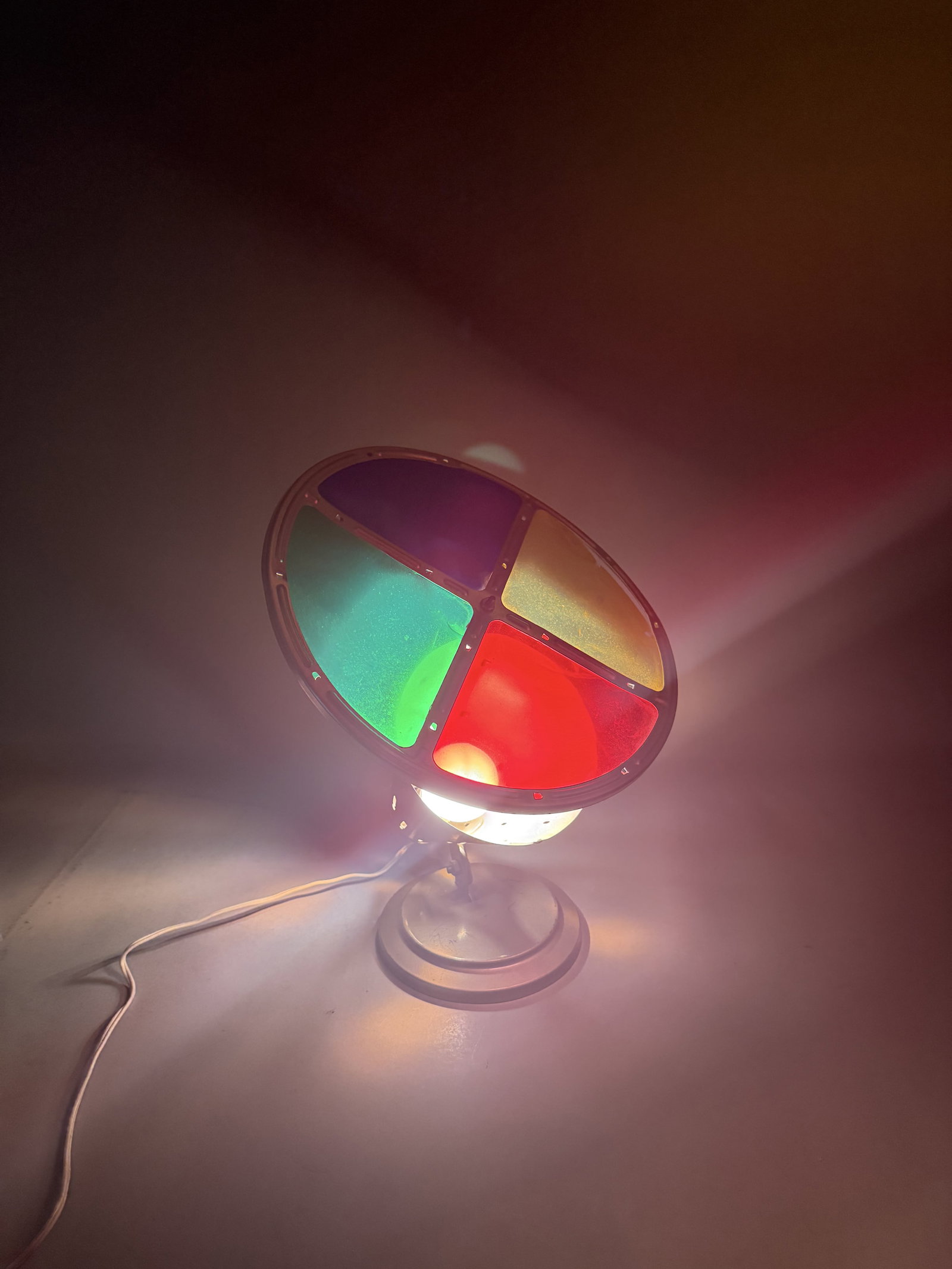 Mid-Century Rotating Color Wheel Christmas Tree Lamp: This vintage motorized tabletop color wheel spotlight is a style typically used to illuminate mid-century aluminum Christmas trees, attributed to manufacturers such as Penetray or Compco. The device i