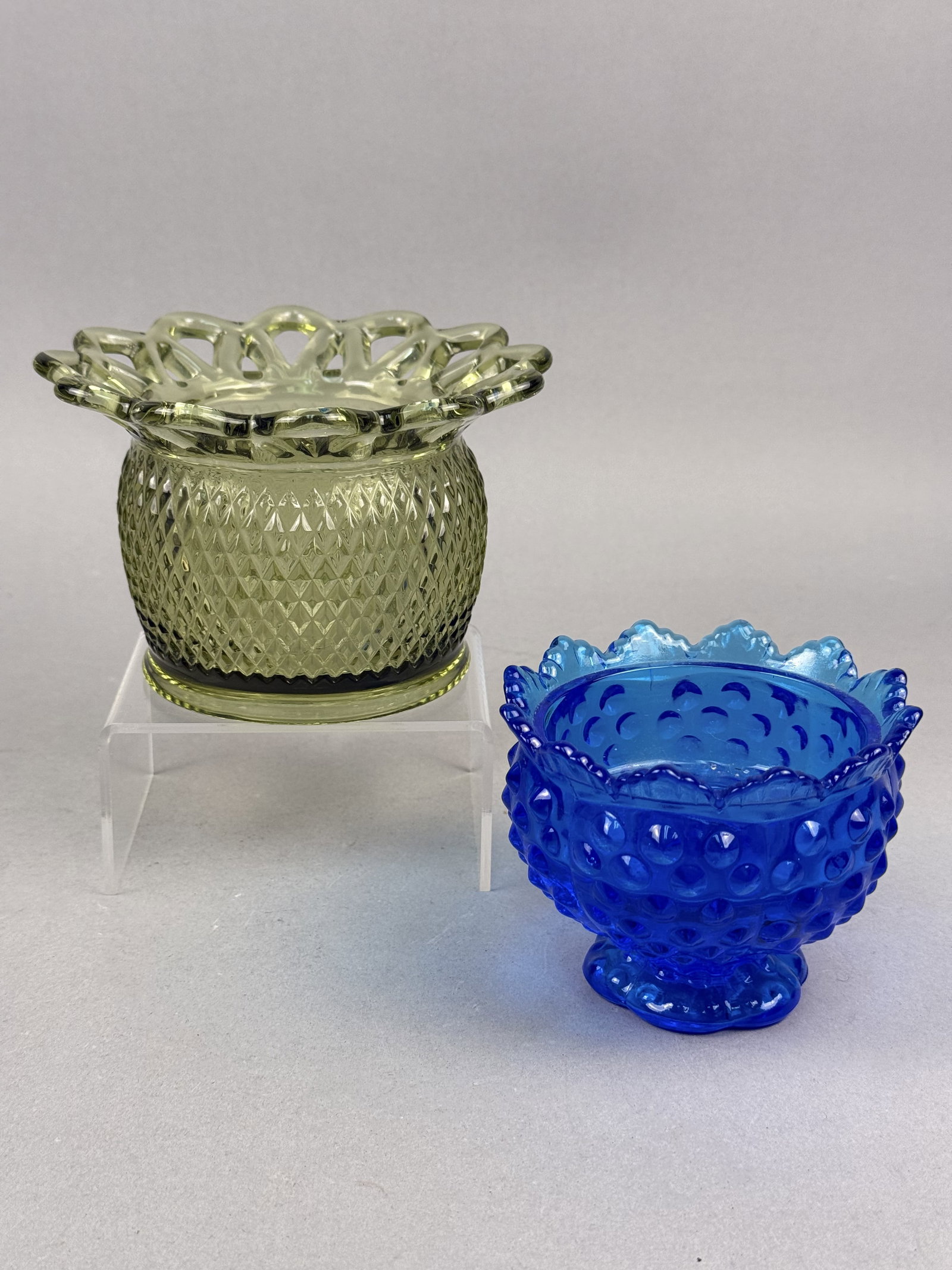 2 Pieces of Art Glass Lace Edge & Blue Hobnail Bowl: This lot contains two examples of American decorative pressed glass from the mid-20th century. The first item is an olive green bowl manufactured by the Imperial Glass Corporation in the Lace Edge
