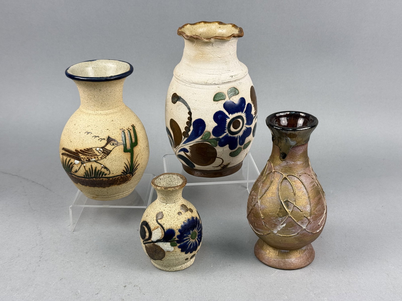 Mexican Studio Pottery Vases: An assortment of Mexican studio pottery vases featuring a variety of forms and decorative techniques. The collection includes a high-fired stoneware vase with a speckled tan matte glaze, hand-painted