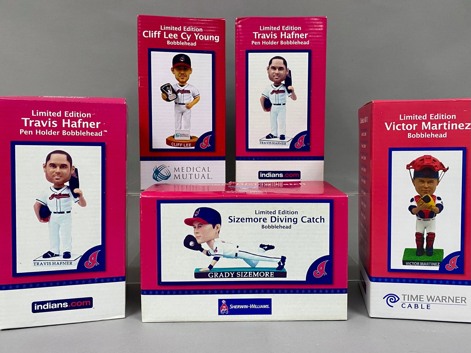 5 Cleveland Indians Giveaway Bobbleheads: This lot features five limited edition promotional bobbleheads issued as stadium giveaways for the Cleveland Indians. The collection includes a Cliff Lee Cy Young Award bobblehead sponsored by