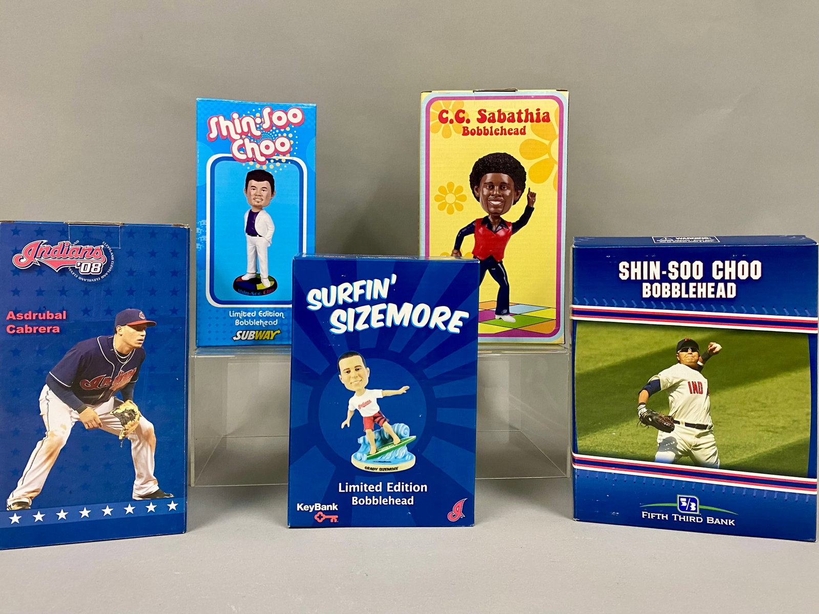 5 Cleveland Indians Giveaway Bobbleheads: This lot consists of five Cleveland Indians promotional stadium giveaway baseball bobbleheads featuring players from the 2000s. The collection includes an Asdrubal Cabrera 2008 fielding pose