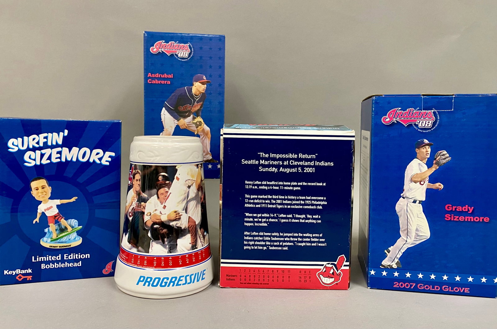 3 Cleveland Indians Bobbleheads & Commemorative Stein: A collection of Cleveland Indians baseball memorabilia consisting of three player bobbleheads and one commemorative ceramic stein. The group includes two Indians 08 series bobbleheads featuring Grady