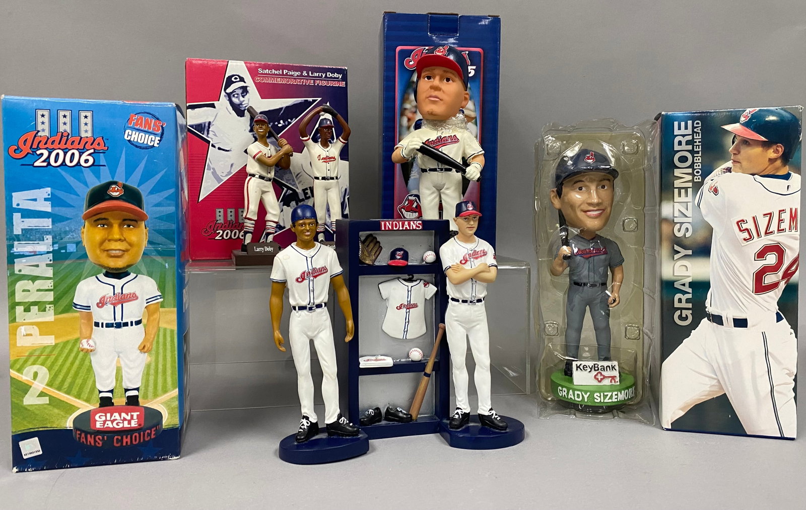 5 Cleveland Indians Bobbleheads & Figurines: A collection of Cleveland Indians baseball promotional memorabilia featuring bobbleheads and figurines from the early-2000s. The lot includes a 2005 Travis Hafner bobblehead in the original box,