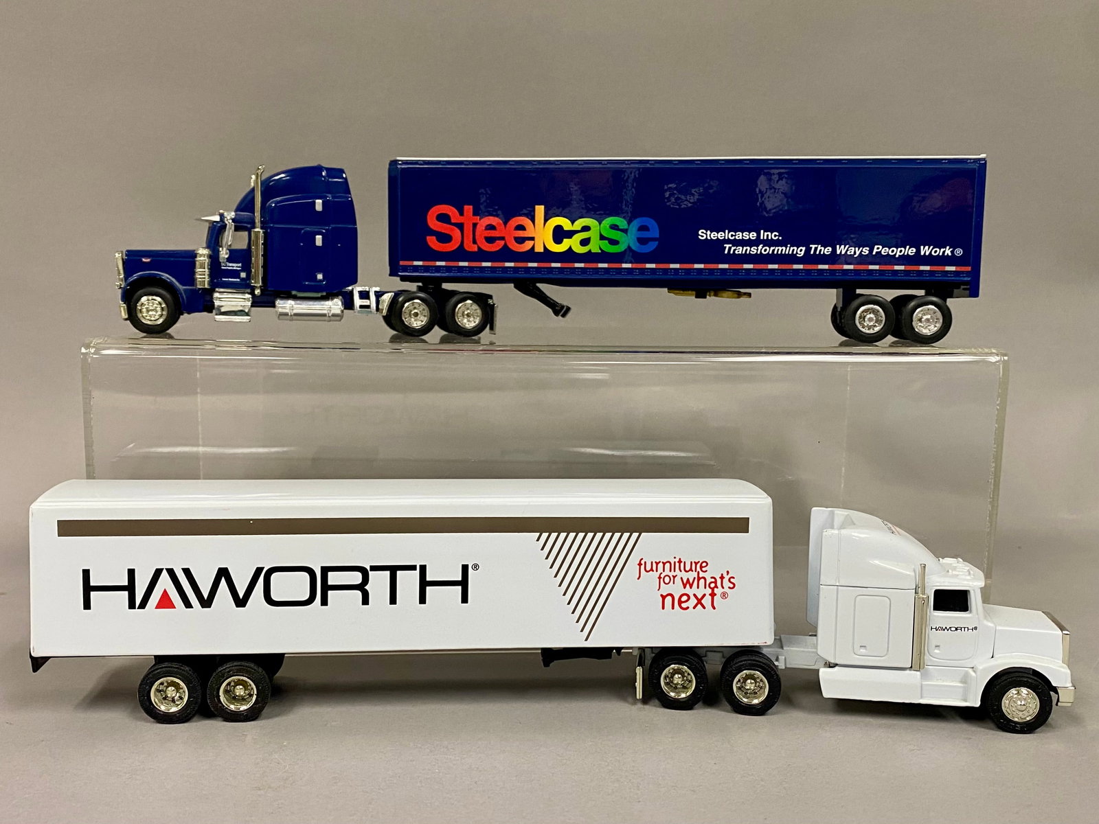 2 Die-cast Peterbilt Semi-Truck & Trailer Promo Models: This lot features two die-cast semi-truck and trailer advertising models representing office furniture manufacturers Haworth and Steelcase. The first model is a Peterbilt Model 377A/E produced by