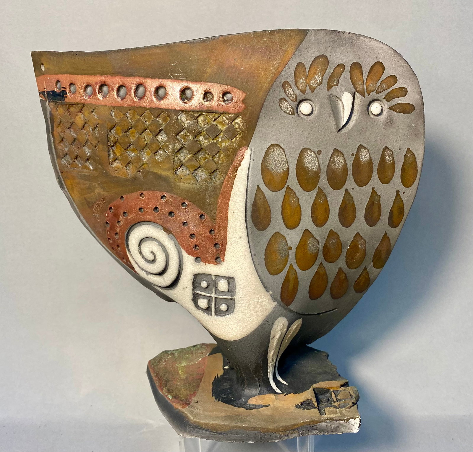 Doug DeLind Raku Studio Pottery Owl Sculpture: A slab-built raku studio pottery sculpture of a stylized owl by American artist Doug DeLind. The piece features a broad, flattened body mounted on an irregular, multi-layered base. The front of the