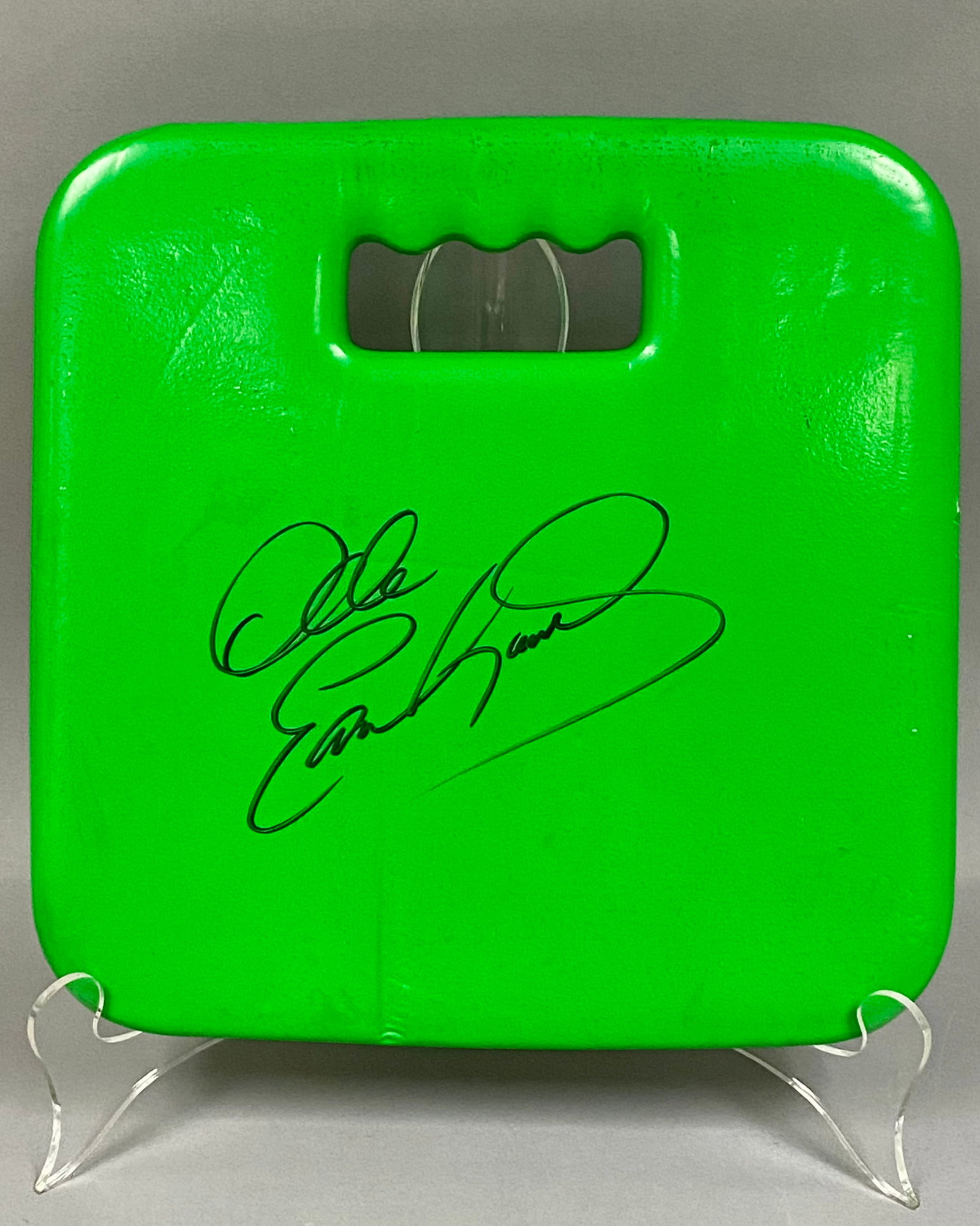 Autographed Dale Earnhardt Sr. Stadium Seat Cushion: This lot features a bright green, square-shaped foam stadium seat cushion autographed by NASCAR driver Dale Earnhardt Sr. The cushion is constructed from a dense foam material with a smooth, coated